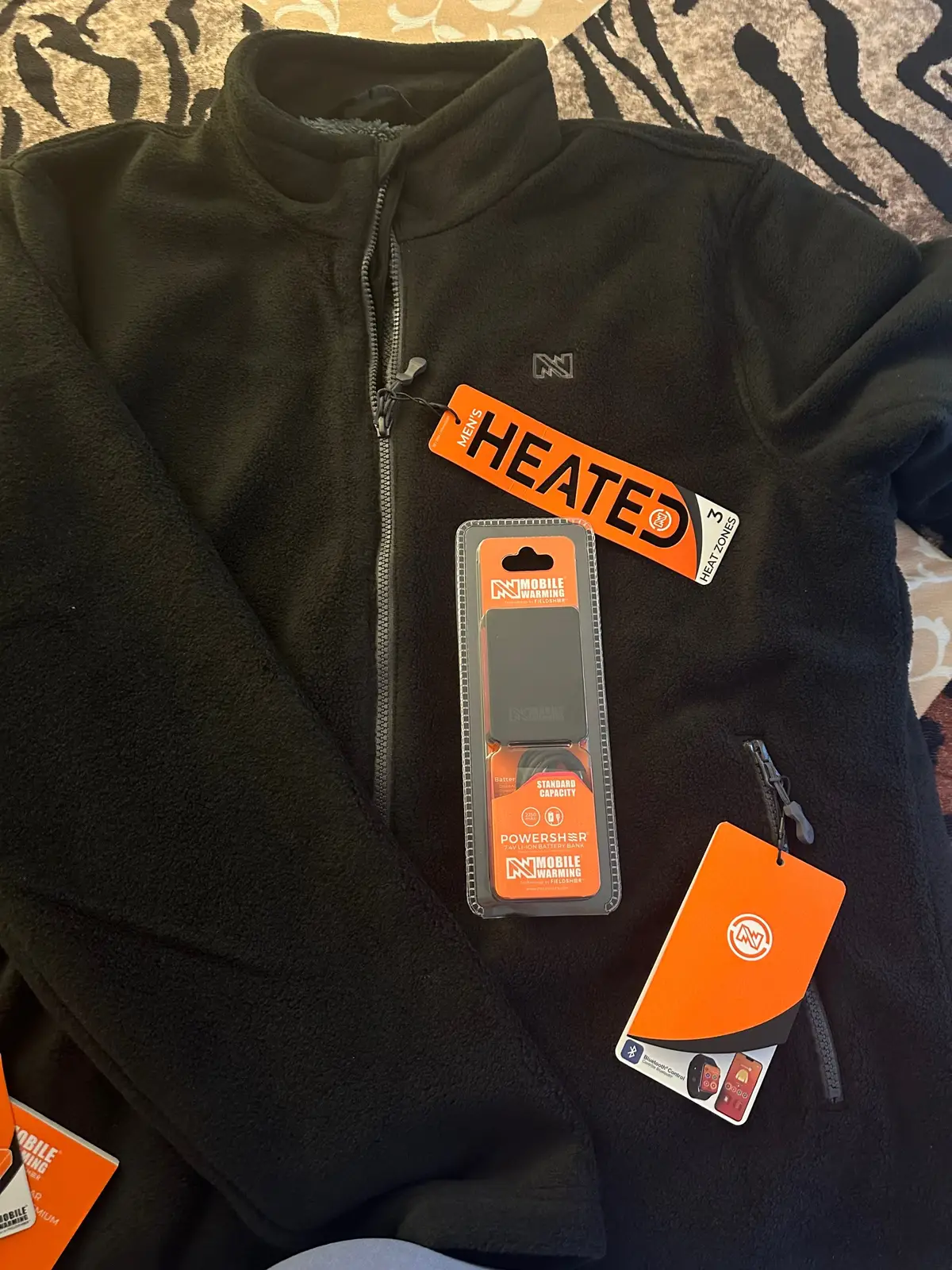 My husband's been living in his Mobile Warming Trek 2.0 Fleece Jacket lately — and for good reason! , The soft fleece and sherpa lining make it super cozy, and the built-in heat zones keep him perfectly warm no matter where we are. He says it fits great (true to size in a men's large) and loves how easy it is to adjust the heat. Simple, comfy, and seriously warm - total win for cold days! #HeatedJacket #WinterReady #CozySeason #WarmthYouCanCountOn @influenster @fieldsheer #gifted