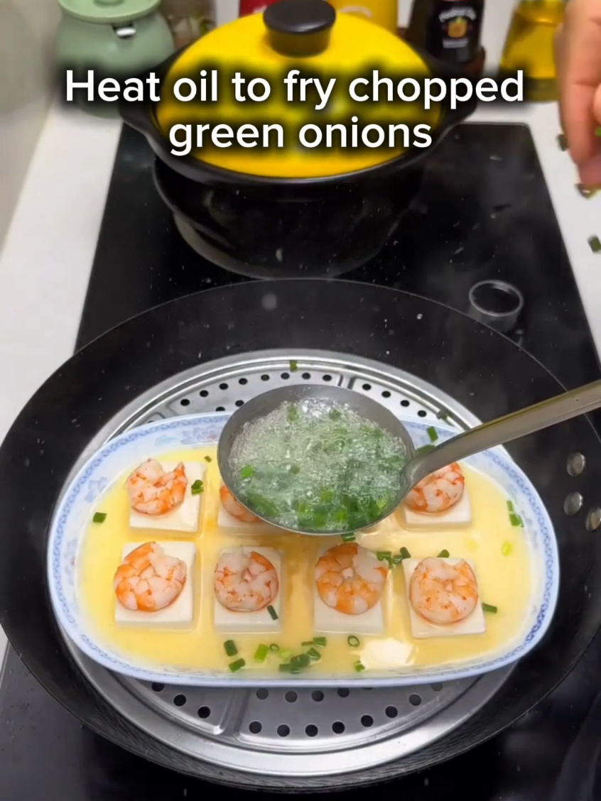 Shrimp Tofu with Steamed Egg   Ingredients   - Tofu ​ - Shrimp ​ - Eggs ​ - Chopped green onions ​ - Salt ​ - Light soy sauce ​ - Cooking oil   Steps   1. Cut tofu into small cubes and place them in a plate. ​ 2. Arrange shrimp on top of the tofu cubes. ​ 3. Beat eggs, add a little salt, stir well and pour into the plate. ​ 4. Once the water boils, steam the plate for 5 minutes. ​ 5. Heat oil to fry chopped green onions and pour them over the steamed dish. ​ 6. Drizzle with a spoonful of light soy sauce and serve.  #ChineseFood  #LAEats  #LosAngelesEats  #AsianFoodFrance 