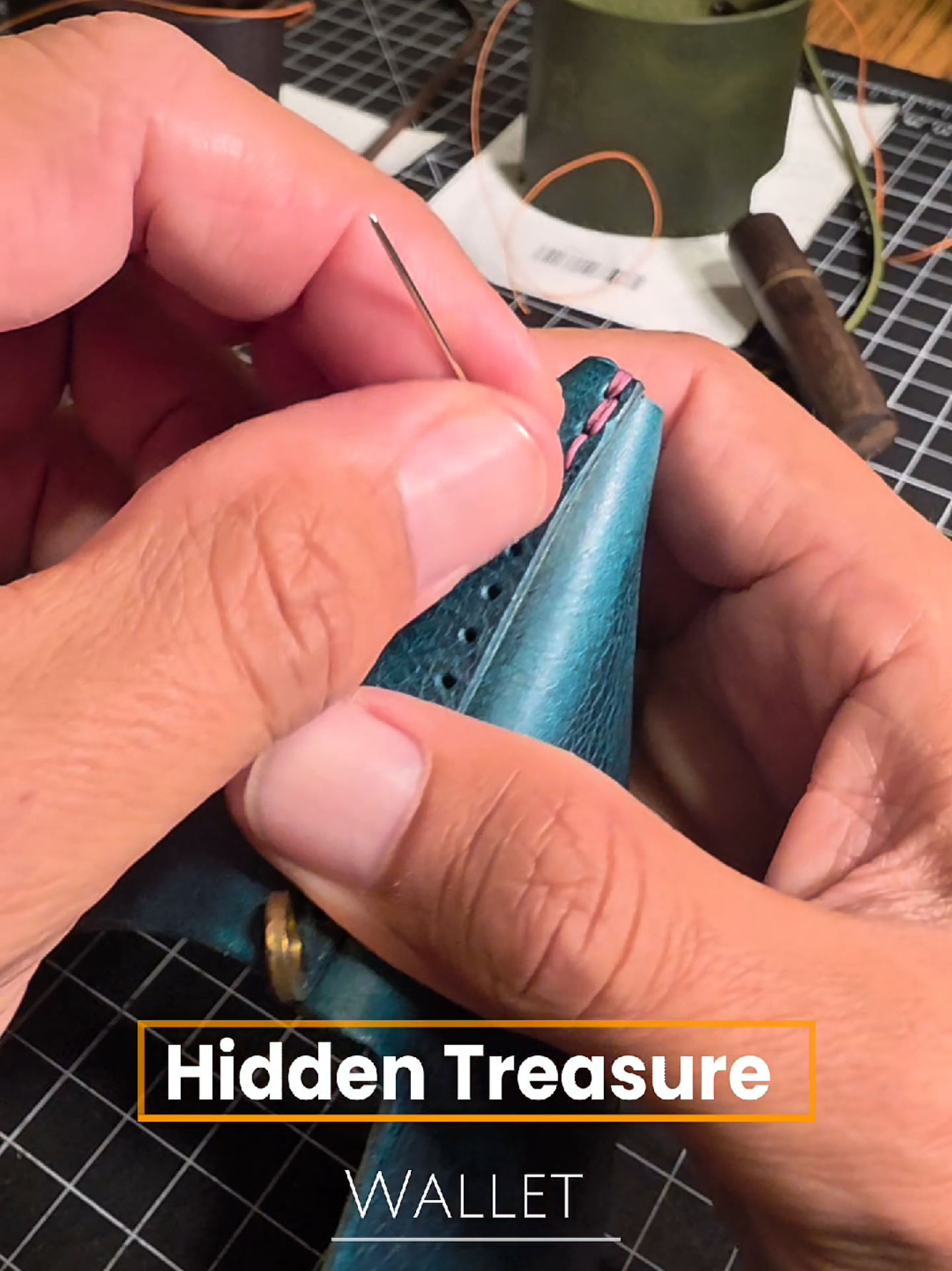 The Hidden Treasure wallet: Waxy turquoise leather with fuchsia thread.