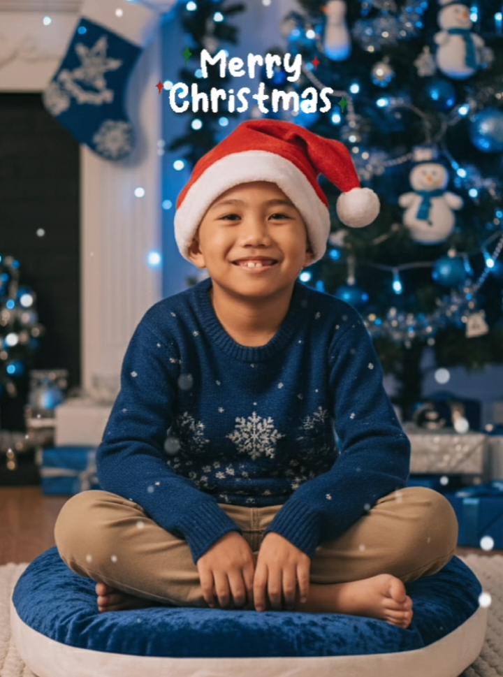 AI Generated: Christmas is Coming!!🎄🎄🎄 Prompt: Create this photo into a realistic blue christmas portrait of a young boy. Make him wear a christmas hat and christmas outfit while sitting in a pillow on the floor and he was beside the christmas tree. Make it warmth and cinematic. Dont change the face. #christmas #christmastok #aigenerated #aigemini #trending 