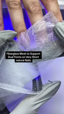 Fiberglass sheet to strengthen and support length on a weak nail. When my client came in, she wanted longer nails but one of her nail beds was too weak to extend directly. If I applied builder gel without extra support, the nail could easily crack on the sides or lift before 4+ weeks. That’s where fiberglass sheets come in 💅 Fiberglass is a thin, flexible mesh made of glass (not microfiber or plastic) that strengthens weak or broken nails. It acts like an internal armor, giving structure and support where the natural nail can’t. 💡 It also helps prevent underside flooding when working with the dual form technique, making your application cleaner and easier to control. Here’s what I did step-by-step: 1️⃣ Applied regular base gel on the natural nail after prep 2️⃣ Filled the dual form with builder gel 3️⃣ Cut a small piece of fiberglass sheet and placed it where her free edge should be 4️⃣ Applied the dual form and cured as usual ✨ The result? A strong, flexible extension that looks flawless and lasts like a full, healthy nail. 💾 Save this for your next challenge set and send it to a nail tech who needs this trick! 💕 #russianmanicure  #gelmani #asmrnails #dualforms
