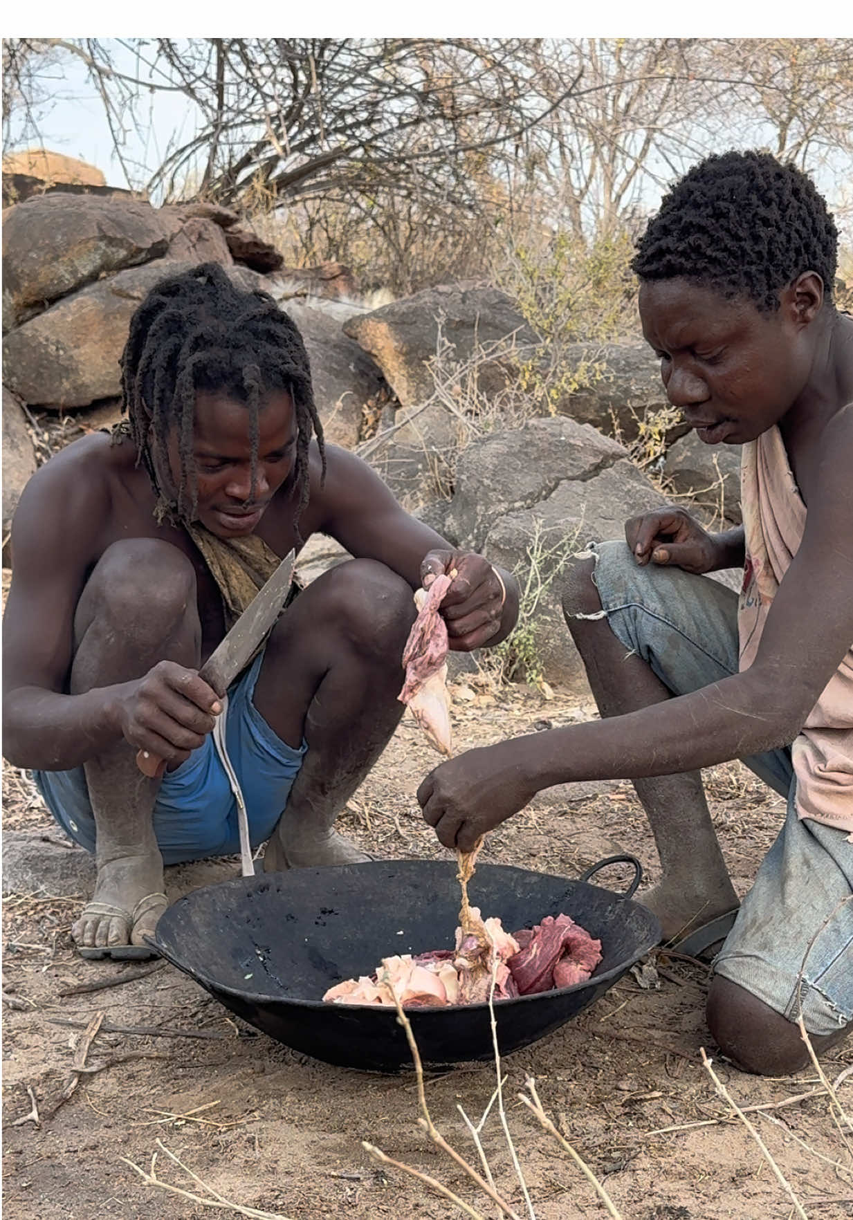 Chaba and his friend are preparing meat for lunch 😇 before cooking, they’re cutting it into small pieces to make it easier to cook and share with everyone. Soon, it’ll be a delicious meal enjoyed together with friends and family — Hadzabe style ❤️🔥 #chaba #friendship #lunchtime #meatlover 