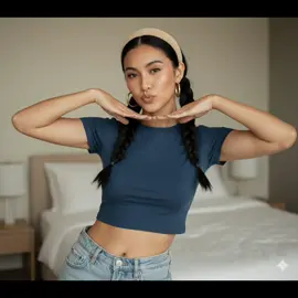 Gemini Ai Prompt : A hyperreal editorial portrait of a young female model (upload Photo) captured in a minimal, intimate interior setting. She poses playfully, framing her luminous face with her hands, lips pursed in a soft pout. Her hair is styled in two italian bob, thick black braids, each strand defined with sculptural precision, while a wide beige headband frames her face, accentuating her sharp cheekbones and balanced bone structure. She wears a fitted, deep- blue cropped tee in soft cotton jersey, paired with light-wash, high-rise denim, creating a clean contrast between modern minimalism and casual allure. Her skin glows with a sun-kissed bronze undertone, highlighted by a subtle dewy finish and sculpted natural highlights across the collarbone and midriff. Oversized, polished gold hoop earrings catch the light, injecting a touch of luxury against the otherwise understated ensemble. Shot in 9:16 vertical editorial format with a 35mm lens at f/2.8, ISO 200, 1/160s shutter speed, using natural daylight diffused through a nearby window to create soft, flattering illumination. The background is a blurred, minimalist bedroom interior in neutral tones, enhancing the model's presence in the frame without distraction. The cinematic color grading leans toward warm creams and deep blacks, subtly lifted with fine editorial Brom realism. The mood is playful yet refined, evoking a sense of casual luxury reminiscent of an off-duty Vogue diary series. Style Tags: Casual luxury editorial, Vogue off-duty, cinematic natural light, playful minimalism, sun-kissed skin, 35mm shallow DOF, understated opulence, gold hoop accent, hyperreal bedroom portrait. #Gemini #ai #fyp #foryou 