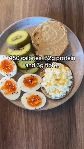 Breakfast - 450 calories, 32g protein and 3g fibre.  A protein English muffin - half topped with peanut butter and half with cottage cheese and a little hot honey drizzled over.  2 air fryer “boiled” eggs with homemade everything bagel seasoning and a golden kiwi. #breakfast #breakfastideas #highproteinbreakfast #highproteinrecipes #breakfastrecipe #healthygirl #caloriedeficitgirls 