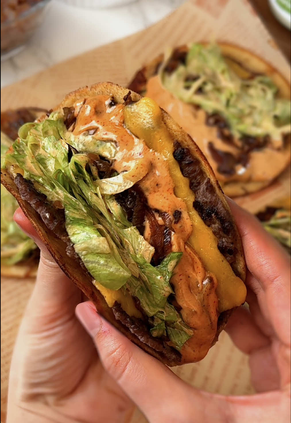 Smash Burger Tacos Crispy, juicy and cheesy, this recipe takes your taco game to the next level. Made with @Chosen Foods 100% pure avocado oil and mayo for that perfect creamy sauce ✨ad Ingredients: 	•	700 g (1 - 1.5 lb) ground beef 	•	8–10 mini tacos 	•	10 slices cheddar cheese 	•	1 cup chopped lettuce 	•	Salt to taste  •  Caramelized onion  Sauce 	•	3 tbsp @chosenfoods avocado mayo 	•	2 tbsp ketchup 	•	1 tbsp Dijon mustard 	•	2 tbsp pickle juice or rice vinegar 	•	1–2 tbsp caramelized onion 	•	1 tbsp paprika 	•	1 tbsp chili powder 	•	1 tsp black pepper 	•	1 tbsp garlic powder 	•	Salt to taste Instructions: 	1.	Form small beef balls, then smash them thin inside the tacos. 	2.	Season with salt and black pepper. 	3.	Heat @chosenfoods avocado oil in a pan, place the tacos upside down, and add a slice of cheddar on top. 	4.	Prepare the sauce, add it inside the tacos with lettuce and caramelized onions. 	5.	Fold the tacos in half and enjoy. #chosenpartner #highprotein #tacos #EasyRecipe #burger                  