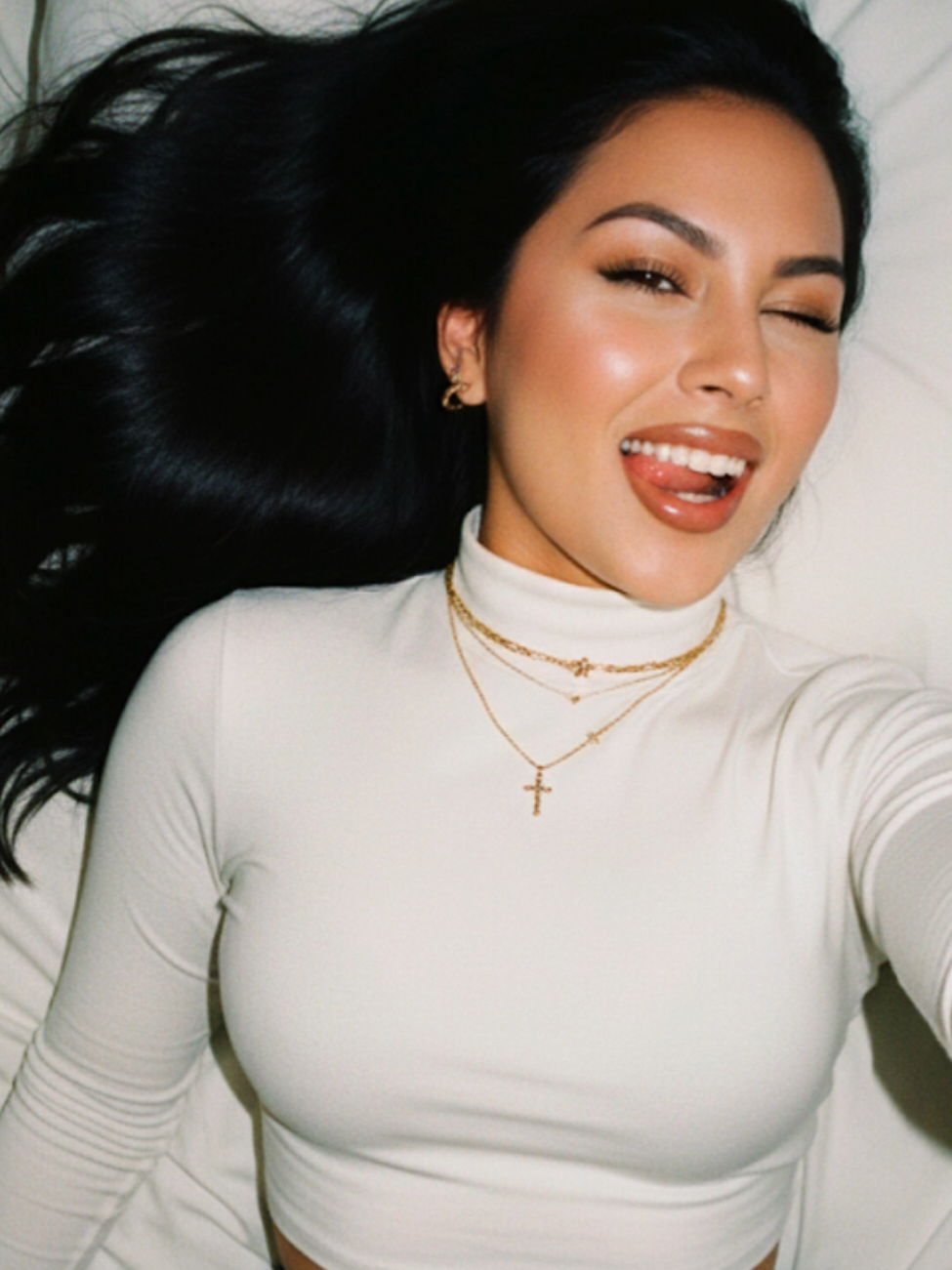 #aiphoto #googlegeminiai #geminiai #prompt 4theLadies Prompt:Create Use photo to create an Internal selfie portrait with flash lighting and playful yet confident expression taken with a compact point-and-shoot camera.long,black hair Expression: Normal innocent angle, looking directly at the camera tongue slightly out smiling playfully winking Pose: lying on the bed side ways, angled Face: sharp focus with high contrast direct flash,makeup natural with brown lipliner glossy,no expression blur Top: white turtle neck long sleeve crop top  Background: black mini skirt  Accessories: Layered necklace: small cross necklace  Bracelets: small gold bracelet  Earrings: Small gold ring earrings Visual Effects: Lighting: Direct flash on camera, strong highlight style, deep dark shadows in background Film grain: analog coating, instant 2000s aesthetic, medium texture, with flash flower visible Tom: casual inner party, warm skin tones with neutral shadows Motion Blur: None Bokeh: None, flat background: Type: Interior room Details:al sheets, dim ambient light mainly dominated by flash : casual snapshot, flash photography, early 2000s aesthetic, sincere playful Aspect Ratio: 3: 4..don't change my face