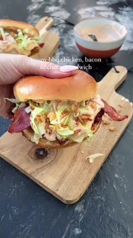 Crispy BBQ Chicken & Bacon Sandwich 😍  With a hot sauce mayo, melted cheese and crispy onions for good measure 😮‍💨 quick, easy and most importantly BANGIN  ‼️ Want more easy recipes? My cookbook “Low-Cal Kitchen Bangers” IS ONLY £11 ON AMAZON! I don’t know how long it will be this price for so RUN to grab a copy through my bio 💕 Ingredients (serves 2): 2 x 100g chicken breasts  1 and ½ tsp bbq seasoning  Tsp smoked paprika  30g cornflakes crushed Egg whisked  40g lighter mayo   2 tsp hot sauce 2 streaky bacon rashers  40g bbq sauce 2 half fat cheddar slices 2 brioche buns  2 handfuls of shredded lettuce Tsp crispy onions 💕Start by seasoning the chicken breasts all over with the bbq seasoning and smoked paprika.  💕Use the remaining ½ tsp bbq seasoning to mix into the crushed cornflakes.  💕Dip each chicken breast into the egg, shaking off any excess before dipping into the cornflakes. Push in to adhere before air frying for 17 minutes at 185 degrees celsius, turning part way through. Alternatively, bake for 20-22 minutes at the same temperature.  💕In a bowl, mix together the mayo and hot sauce until well combined.  💕Cook the bacon according to packet instructions.  💕When there is 2 minutes remaining on the chicken, brush over the bbq sauce before topping with the cheese slices. Note - I blast my bbq sauce in the microwave for 15 seconds to make it easier to brush!  💕Whilst the cheese melts, lightly toast the brioche buns.  💕Top the bottom bun with the chicken, along with the cooked bacon.  💕Add half of the sauce on top, followed by the shredded lettuce. 💕Use the remaining sauce on the remaining bun to top. Calories per portion: 506 l Protein: 45g l Fat: 12.1g l Carbs: 52.3g  • • _____ #crispychicken #sandwich #burger #bbqsauce  #DinnerIdeas #mealideas #healthyrecipes #lowcaloriemeals #highprotein #EasyRecipes #weightlossfood 