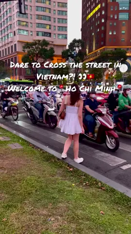 🚶‍♀️Dare to Cross the Street in Vietnam? 👀🌟 Welcome to Ho Chi Minh City's Ultimate Traffic Challenge! 🚦 Watch how locals and tourists alike navigate the bustling streets without ever stopping the flow of traffic. Are you brave enough to try it? 😱🇻🇳  Driving in Vietnam can look chaotic, but it’s actually all about flow and adaptation! Here’s why traffic works the way it does💁‍♀️:   1. Cultural Norms and Adaptation: ✅ In Vietnam, drivers often rely on a natural flow or rhythm 🚘 rather than strictly adhering to traffic rules. People are used to navigating crowded streets, and there's an unspoken understanding or mutual awareness among drivers and pedestrians🤔. Instead of stopping at intersections, drivers often slow down and weave through traffic to maintain momentum👀. Also, drivers are typically defensive and hyper-aware of their surroundings, which allows them to anticipate and avoid potential accidents even in seemingly chaotic traffic 🤓 2. Motorbike Dominance: ✅ Motorbikes are the primary mode of transportation in Vietnam due to their affordability, fuel efficiency, and ability to navigate narrow streets and heavy traffic🛵. The sheer number of motorbikes (millions in cities like Ho Chi Minh City) makes strict adherence to traffic signals impractical. Motorbikes can easily maneuver through spaces and gaps that cars cannot, contributing to a more fluid, less structured flow of traffic🚦 3. Infrastructure: ✅ Many streets weren’t designed for modern traffic, leading to congestion. Drivers adapt by weaving through traffic instead of waiting at signals 🛑 4. Practical Reasons: ✅ Keeping a steady pace is more time and fuel-efficient, crucial for daily commutes and deliveries. 🌿 5. Enforcement: ✅ Traffic laws 👮‍♂️are not always strictly enforced, so drivers feel more freedom to interpret rules flexibly. Despite how it looks, this system works for locals, who learn to drive by experience and observation! #vietnamadventures #vietnam #vietnamese #vietnam🇻🇳 #việtnam               
