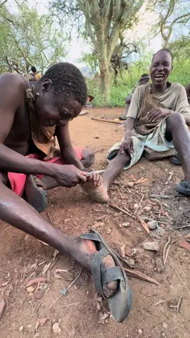 Chaba cutting Gingidaa’s toenails — Hadzabe style! 😄 Out here, grooming is all-natural and done the traditional way. Chaba is carefully trimming Gingidaa’s toenails using his sharp tool — no salon, no fancy kit, just pure Hadzabe skill and simplicity. That’s how they keep things clean and practical in the wild! 😇 #chaba #toenails #gingidaa #nailsvideotutorial #tanzaniavibes 