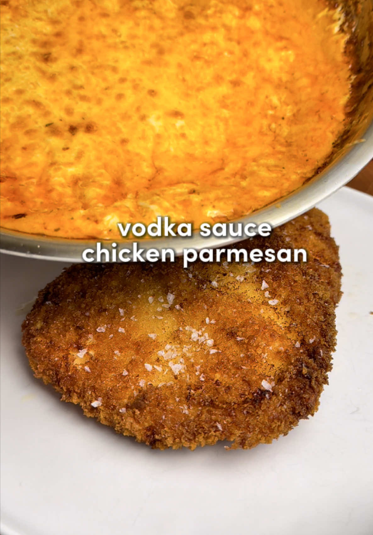 Chicken Parm with Vodka Sauce 🔥 Crispy golden chicken, creamy vodka sauce, and bubbling mozzarella… the ultimate cozy comfort dinner 🫠 For the cutlets: -3 boneless chicken breasts, butterflied -2 large eggs -1.5 cups panko breadcrumbs (more if needed) -1 cup all-purpose flour (more if needed) -1 cup avocado oil from @Primal Kitchen Foods for frying (or enough to create a shallow 1/2-inch layer). -Flour seasoning: 1 tbsp paprika, 1 tbsp garlic powder, 1 tbsp onion powder, 2 tsp salt, 1 tsp black pepper For the vodka sauce: -2 tbsp butter -7 garlic cloves, minced -1 large shallot, diced -2 tbsp tomato paste -1/3 cup vodka (optional) -1 cup heavy cream (room temp) -Sauce seasoning: 2 tsp Italian seasoning, 1 tsp garlic powder, 1 tsp salt, 1 tsp black pepper, 2 tsp red chili flakes -1/2 cup freshly grated Parmesan -1 cup fresh mozzarella, shredded (for broiling on top) Instructions: 1. In an oven-safe pan, melt butter over medium heat. Add shallots and cook 3–4 minutes until soft. Add garlic and sauce seasonings; cook 1 minute. Add tomato paste and cook 2 minutes until darker. Pour in vodka, simmer 2 minutes, then slowly add cream. Stir in Parmesan and simmer 3–5 minutes until the sauce thickens but stays pourable. Remove from heat. 2. Butterfly the chicken breasts. Cover with plastic wrap and pound to an even 1/4-inch thickness. 3. Set up 3 bowls: seasoned flour, beaten eggs, and panko. Coat each piece of chicken in flour, then egg, then press firmly into panko until fully covered. 4. Heat avocado oil over medium-high. Once hot, fry cutlets 3–4 minutes per side until golden and crispy. Transfer to a rack or paper towels. 5. Preheat oven to broil. Spread the shredded mozzarella in an even layer over the cooled slightly vodka sauce (don’t mix it in). 6. Broil 2–3 minutes, watching closely, until the cheese melts and bubbles.. don’t burn it though. 7. Spoon or pour the cheesy vodka sauce over the fried cutlets. Finish with fresh basil and serve hot.