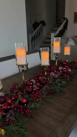 ✨🎄 A luxuriously charming Christmas centerpiece ✨🎄 From wispy Norfolk pine garlands layered with deep burgundy picks to rich ornaments and pinecones, all tied together with twinkling lights and glowing candlelight… everything came together into this warm, elegant holiday centerpiece. Would you recreate this for your holiday dinner? Follow for more Christmas inspo + festive styling ideas ❤️✨ #ChristmasDecor #ChristmasTablescape #HolidayCenterpiece #ChristmasDIY  #ChristmasCenterpiece  