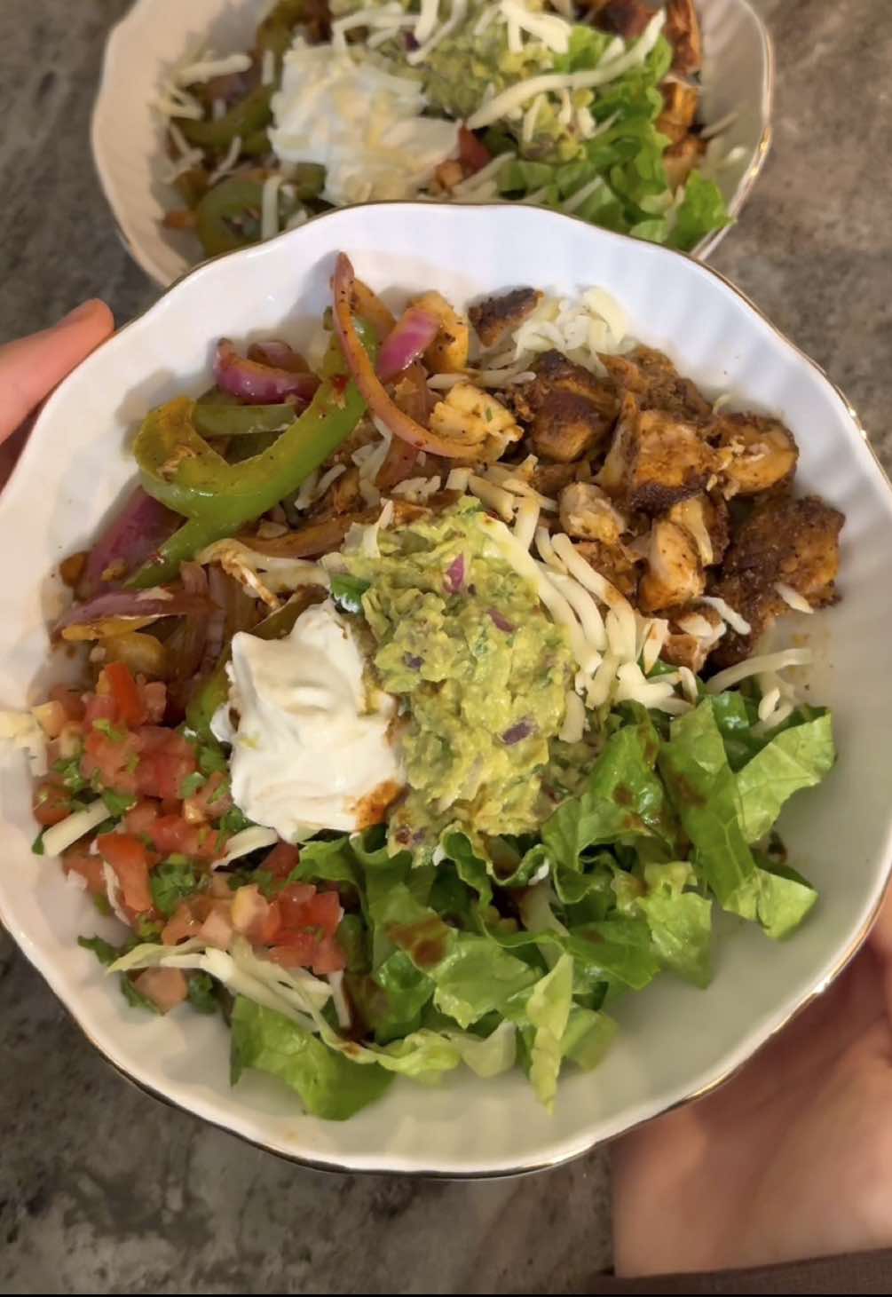 Easy Chicken Rice Bowl 🍲 Ingredients: 3 boneless, skinless chicken thighs 1 tbsp olive oil ½ tbsp paprika ½ tbsp garlic powder ½ tbsp black pepper ½ tbsp salt 1 tsp oregano ⅓ cup chipotle peppers in adobo sauce Marinate: Mix everything together and marinate the chicken while you prep the rest (or overnight for best flavor). Fresh Tomato Salsa: 1 Roma tomato, diced ¼ cup chopped cilantro 1 tbsp lime juice Salt & pepper to taste Mix everything in a small bowl and set aside. Fajita Veggies: ½ green bell pepper, sliced 1 small red onion, sliced 1 small white onion, sliced 2 garlic cloves, thinly sliced 1 tsp red pepper flakes 1 tsp salt & pepper Sauté in olive oil over medium heat until tender (about 3–5 minutes). Guacamole: ½ avocado ¼ cup finely chopped red onion 2 tbsp chopped cilantro 1 tbsp lime juice 1 tsp red pepper flakes Salt & pepper to taste Mash together until creamy. Cilantro Lime Rice: 2 cups cooked white rice ⅓ cup chopped cilantro Juice of ½ lime Salt & pepper to taste Mix well and set aside. Optional toppings:  Lettuce Sour cream Mozzarella cheese Instructions -Heat 2 tbsp olive oil in a pan over medium heat. -Cook chicken for about 5 minutes per side, or until nicely seared and the internal temperature reaches 165°F. -Remove from the pan and let it rest. - Make the tomato salsa, guacamole, and cilantro lime rice. Set aside. -In the same pan used for the chicken, sauté the fajita veggies with their seasonings for 3–5 minutes on medium heat. Assemble Your Bowl: Layer cilantro lime rice, sliced chicken, fajita veggies, salsa, and guacamole, lettuce, sour cream, mozzarella cheese and Enjoy! #chicken #rice #bowl #lunch #dinner