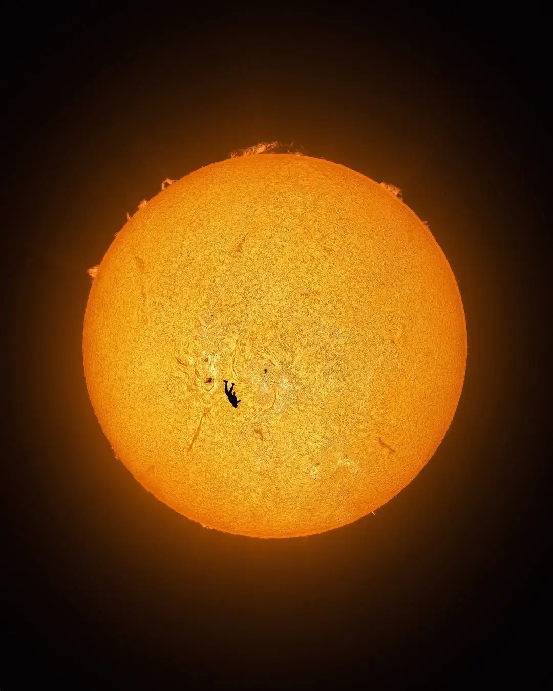 A photographer, Andrew McCarthy, captured what looks like a skydiver falling past the sun’s surface, even though the skydiver is 50 million times closer to the camera than the sun. The shot, called “The Fall of Icarus,” required extreme precision. The photographer set up telescopes in the desert and had his friend jump from a small aircraft positioned perfectly between him and the sun. They had to calculate the right location, time, aircraft distance, the power-off glideslope for the optimal sun angle, and safe exit altitude. It took six attempts to line up the aircraft with the sun before the skydiver finally jumped. They coordinated the exact moment on three-way comms while dealing with multiple malfunctions that almost prevented the shot. The skydiver jumped from around 3,500 feet, about 8,000 feet from the camera. They only had one chance—repacking the parachute would have taken too long for another attempt. The sun is currently in its most active phase of its 11-year cycle, making the solar surface particularly dramatic. The photographer called it “the most preposterously fake-looking real photo I’ve ever captured” and said it might be the first photo of its kind in existence.