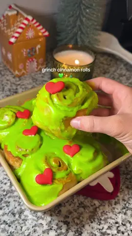 Grinch cinnamon rolls💚✨🎄RECIPE BELOW⬇️ INGREDIENTS: •1 and 1/8 tsp instant yeast •1/4 cup warm water •1/4 cup lukewarm milk (scalded then cooled) •2 tbsp+2 tsp granulated sugar  •2 1/2 tbsp butter at room temperature  •1/2 tsp salt  •1 small egg •1 3/4-2 cups all purpose flour (start with 1 3/4 cup) •1/2 cup heavy cream  For the filling: •2 tbsp butter at room temperature  •1/4 cup sugar and 2 tsp cinnamon mixed together  For the frosting: •1 cup powdered sugar •1 tbsp milk •1 tsp vanilla •2 tbsp butter at room temperature  •a few drops of neon green food coloring  Pour the yeast and warm water into a bowl and mix until the yeast is dissolved. Then mix in the butter, milk, sugar, salt, egg, and flour (start with 1 3/4 cup flour). Knead the dough by stand mixer or by hand until a smooth dough is formed. Add in the rest of the flour if the dough is too sticky. Place the dough ball in a greased bowl, cover and let sit until it’s doubled in size (should take about 1- 1/2 hours) Flatten and roll the dough into a rectangle about 15x9 inches. Spread over the 2 tbsp butter and the cinnamon sugar mixture. Roll the long side into a tight roll, pinching the edge of the dough closed. Cut the log roll into 9 equal pieces, I like to use floss for this!  Place the cinnamon rolls in a greased pan slightly apart, cover and let rise again until they are about doubled (1-2 hours). Pour heavy cream over and between the cinnamon rolls, then bake at 375 degrees Fahrenheit for 15-18 min or until golden on top. While those are baking, mix the butter, powdered sugar, milk, vanilla, and neon green food coloring together. To create the frosting. Let the cinnamon rolls cool off, frost them while slightly warm. Top with red candy hearts and enjoy♥️ #holidayrecipe #holidaybaking #grinch #christmasbaking #cinnamonroll 