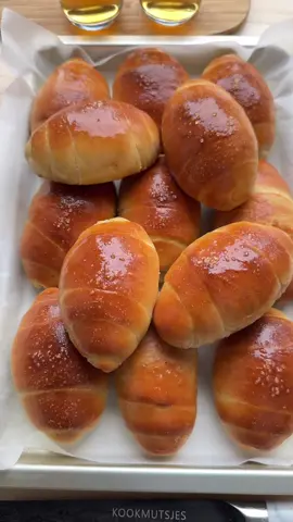 FLUFFY CRISPY SALT BREAD  #food #Recipe #korean #fy #foryoupage❤️❤️  DOUGH 225 ml lukewarm milk 175 ml lukewarm water 8 g instant yeast 25 g granulated sugar 600 g strong white flour (bread flour) 9 g salt 60 g unsalted butter FILLING 195 g unsalted butter EXTRA water salt TOPPING unsalted butter Pour the lukewarm milk, lukewarm water, yeast, and sugar into a large bowl. Mix well and let it stand for 5 minutes. Add the flour and salt. Knead for 5 minutes. Add the softened butter and knead for 10 minutes until the dough is smooth and elastic. Cover and let the dough rise for 1 hour in a warm place, or until it has doubled in size. Punch down the dough and divide it into 13 equal pieces of about 80 g each. Shape each piece into a ball. Take one ball and roll it flat with a rolling pin. Roll the dough tightly into a log. Seal the seam well. Roll it back and forth briefly, then roll it flat again with a rolling pin, from a wider base towards a point. Cut the cold butter into blocks of about 15 g each. Place a block of butter at the wider end of the rolled-out dough and roll it up tightly so the butter is fully enclosed, forming a croissant-like shape. Place the dough on a baking tray lined with baking paper. Brush with water and sprinkle with salt. Let rise for 30 minutes, or until the rolls have doubled in size. Bake the rolls in a preheated oven at 200°C (390°F) for 12–18 minutes, until beautifully golden brown. Let cool. Brush with melted butter for a glossy finish. Tips: - Use truly lukewarm milk and water. If the water is cold, the yeast will work more slowly; if it’s too hot, the yeast will die. The perfect temperature is around 35–38°C (feels just warm on your finger). - The butter blocks must be cold because you’re rolling firm butter inside the dough. This keeps the butter in place and ensures it melts only in the oven. - Keep an eye on the baking time, every oven behaves differently.