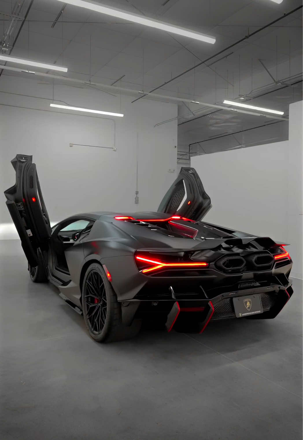 This #Revuelto in #NeroNemesis features a #RossoMars pinstripe diffuser livery, Q-Citura stitching, passenger display, and much more! Available now at the link in our bio! #LamborghiniSanAntonio #LamborghiniRevuelto   Contact us! 210-600-5770