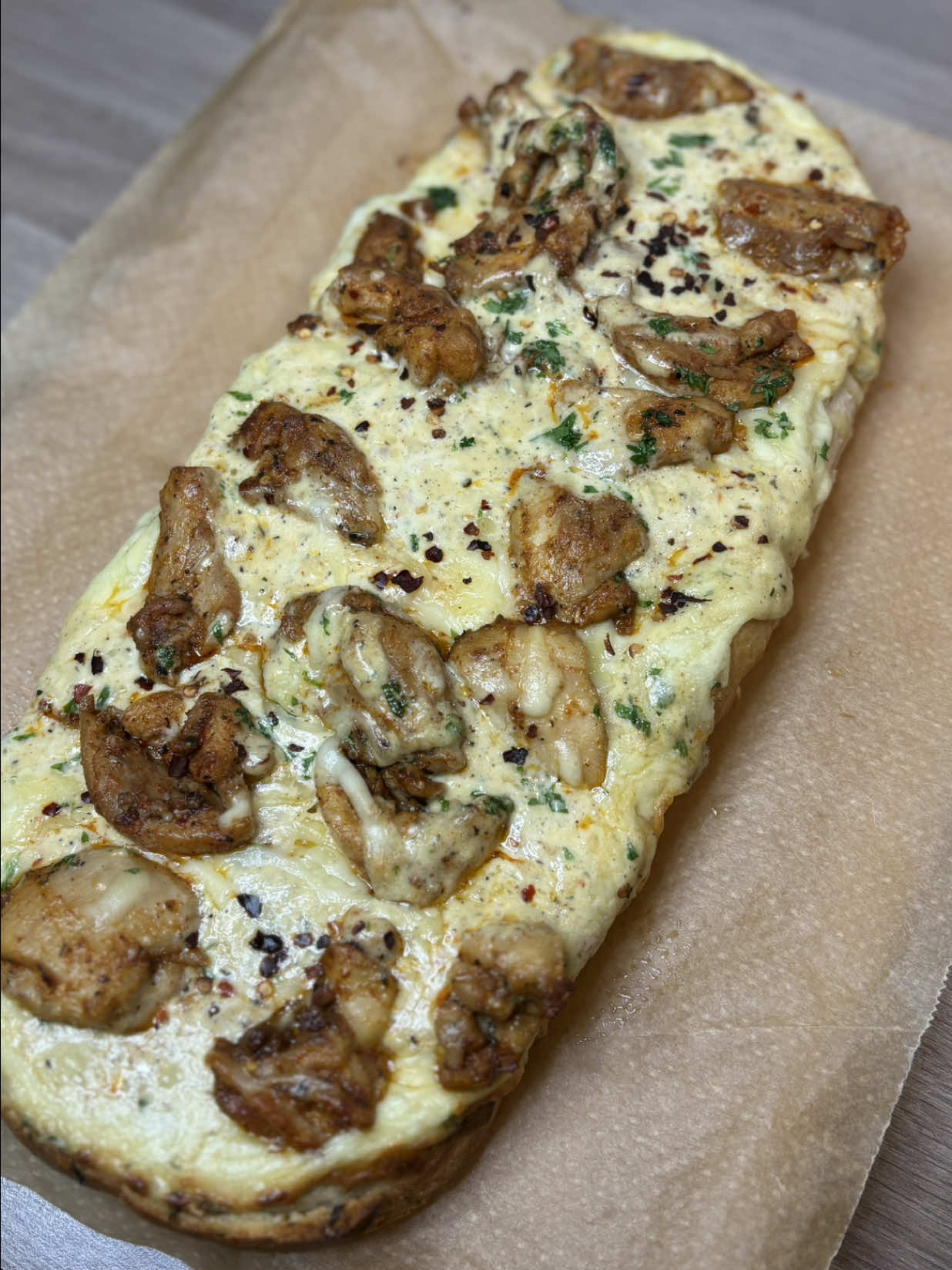 Chicken Alfredo garlic bread  For the Chicken 500 g diced chicken thighs (about 1 lb) 1 tbsp olive oil 1 tsp salt ½ tsp black pepper 1 tsp garlic powder 1 tsp Italian seasoning 1 tsp chilli flakes  1 tsp all purpose seasoning  ½ tsp paprika (optional) For the Alfredo Sauce 2 tbsp butter 3 cloves garlic, minced 1 cup (240 ml) heavy cream ½ cup (50 g) grated Parmesan ½ cup (50–60 g) shredded mozzarella (your version) ½ tsp salt ½ tsp black pepper ½ tsp Italian seasoning 1/2 tsp chilli flakes  1/2 all purpose seasoning  1/2 tsp onion powder  Garlic Butter 4 tbsp (55 g) softened butter 3 cloves garlic, minced 1 tbsp chopped parsley 1/2 tsp black pepper  Handful Parmesan cheese  Pinch of salt Assembly 1 large French bread loaf 1–1½ cups shredded mozzarella (for topping) Extra parsley for garnish 1. Cook the Chicken Heat 1 tbsp olive oil in a pan. Add diced chicken thighs. Season with: salt, pepper, garlic powder, Italian seasoning, and paprika. Cook until browned and fully cooked. Remove from heat. 2. Make the Alfredo Sauce Add 2 tbsp butter to the same pan. Add minced garlic and cook 30 seconds. Pour in 1 cup heavy cream and let simmer 2–3 minutes. Add Seasoning . Stir in Parmesan until fully melted. Add mozzarella and melt it into the sauce  Simmer until thick and creamy. 3. Make Garlic Butter Mix softened butter, garlic, parsley, pepper, cheese,salt in a small bowl. 4. Assemble  Slice the French bread loaf in half lengthwise. Spread garlic butter generously over the bread. Pour the Alfredo sauce on top. Cover with shredded mozzarella. Add a full layer of cooked chicken thighs. 5. Bake Bake at 200°C (400°F) for 10–12 minutes Broil 1–2 minutes to brown the cheese 6. Serve Slice, garnish with parsley, and enjoy the creamiest, cheesiest chicken Alfredo bread. #chickenalfredo #garlicbread #dinnerrecipe #EasyRecipe