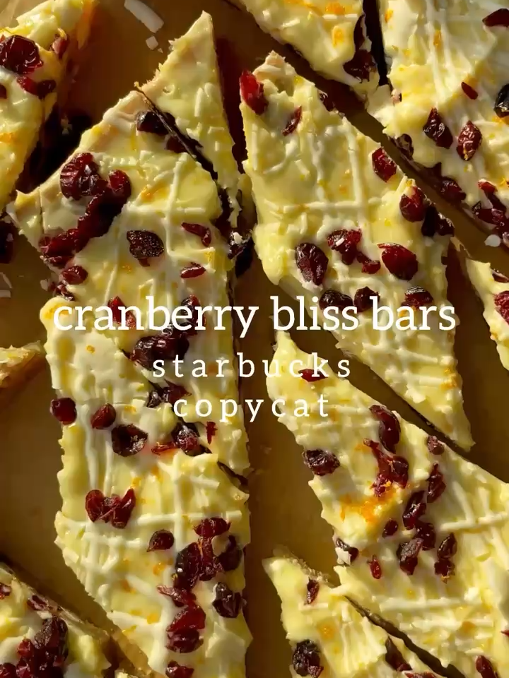 STARBUCKS COPYCAT Cranberry Bliss Bars 😍 recipe linked in bio!💚❤️ I make these every year for parties or get togethers and nothing disappears faster! 🤗 . https://krollskorner.com/recipes/desserts/bars-brownies/cranberry-bliss-bars/ . For the bars: ▢ 1 cup granulated sugar ▢ 1 Tbsp. orange zest (~zest from 1 orange) ▢ 1 cup dark brown sugar, packed (light works too) ▢ 1 cup unsalted butter, melted and slightly cooled ▢ 2 large eggs ▢ 1 Tbsp. vanilla extract ▢ 2 1/4 cups all purpose flour ▢ 1 tsp. baking powder ▢ 1 tsp. cornstarch ▢ 1 tsp. salt ▢ 1/4 tsp. ground cinnamon (or ground ginger) ▢ 1 cup white chocolate chips ▢ 1 cup dried cranberries For the frosting: ▢ 1 cup white chocolate chips ▢ 1 Tbsp. coconut oil ▢ 8 oz. full-fat cream cheese, softened to room temperature ▢ 1 1/2 cups powdered sugar, or more as needed ▢ 1 Tbsp. orange zest ▢ dried cranberries, roughly chopped . #cranberryblissbars #cranberryblissbar #blissbars #holidaybaking #christmasbaking #starbuckscranberryblissbars #copycatrecipe #festivedesserts #holidaydesserts #christmasdesserts #bakingseason #foodblogfeed #bakersoftiktok #christmascookies #holidaysweets #sweettooth #yum #dessertlover #homebaker #EasyRecipes #krollskorner #cranberrydesserts #whitechocolatecranberry #bakedwithlove #tistheseason #christmastok #desserttok