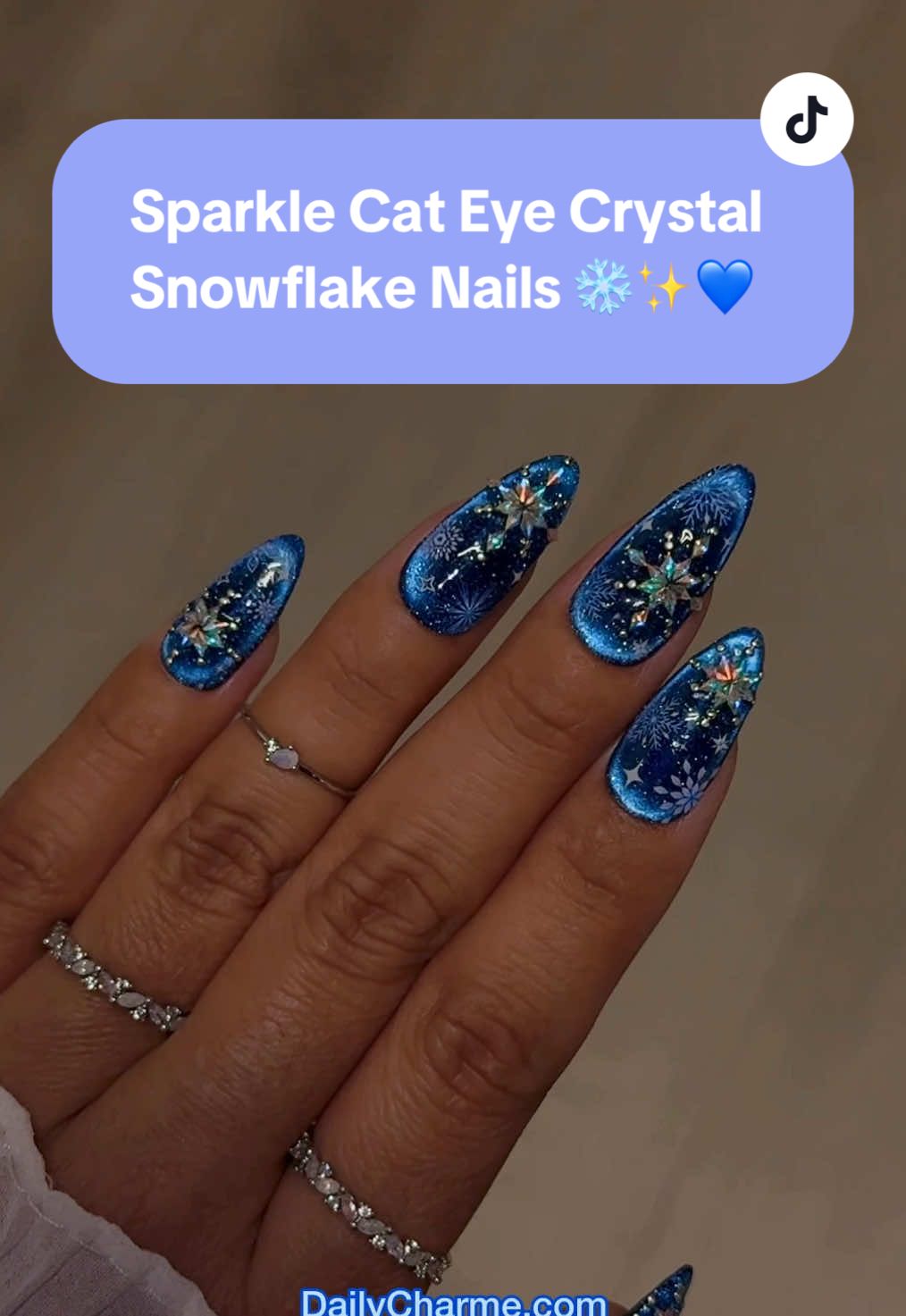 Sparkle Cat Eye Crystal Snowflake Nails ❄️✨💙 An icy, sparkling winter mani that shines like fresh snow!  💅 Everything used for this look is from the brand Daily Charme & is listed below. All goodies are available now in our TikTok shop or via the 🔗 in bi0 💖 Save & share for winter nail inspo! ☃️ Using @daily_charme: 💙 𝗡𝗘𝗪 E59 Cosmo Blue Aura ❄️ 𝗡𝗘𝗪 Holiday Bejeweled Nail Art Sticker / Frosty Snowflake ✨ 𝗡𝗘𝗪 Tiny Rhombus Charme Crystals AB 🪩 Ultra Mini Round Stud / Silver 🌟 Stick On Gelly / Adhesive 2D Jewelry Gel 🧲 Cat Eye Magnet Cylinder Wand 🎀 Pink Nail Art Tweezer 🖌️ 08 Oval Brush 💎 Diamond Shine Top Coat   #snowflakenails #winternails #cateyenails #sparklenails #nailarttutorial          