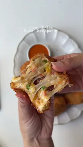 Chicken and potato croquettes  Ingredients  4 large potatoes, peeled and boiled and mashed  1 lb boneless chicken breast, boiled in salt water and shredded  1 cup mixed bell peppers, diced 1/2 cup green onion, diced  2 medium carrots, diced and boiled  1 1/2 cup mozzarella cheese, shredded  2 eggs  4 tbsp corn starch  Salt to taste 1 tbsp chicken bouillon powder 1 tbsp garlic powder  1 tsp onion powder  1 tsp black pepper powder  1 tsp smoked paprika powder  1 tsp red chili flakes Oil for frying For coating: 5 tbsp all purpose flour  1/2 cup water ( less or more to make thick slurry ) 1 cup panko bread crumbs  Method :  In a bowl, combine mashed potatoes, shredded chicken, bell pepper, boiled carrots, and green onions. Season with salt, pepper, paprika powder, garlic powder, onion powder, chicken bouillon powder, and red chili flakes. Add corn starch and crack in the eggs. Add mozzarella cheese. Mix everything thoroughly. Shape the mixture into round croquettes and lay them flat on a clean surface. Make the wet batter: In a separate bowl, whisk together all-purpose flour and water until a thick slurry forms. In another bowl, add breadcrumbs. Dip each croquette in the wet batter, then coat it with breadcrumbs. Heat the oil to 350°F. Fry the croquettes in batches for 3 to 4 minutes, or until they are golden brown and crispy. Serve them with your favorite sauce and enjoy. #croquettes #Recipe #chickenandpotatoes 