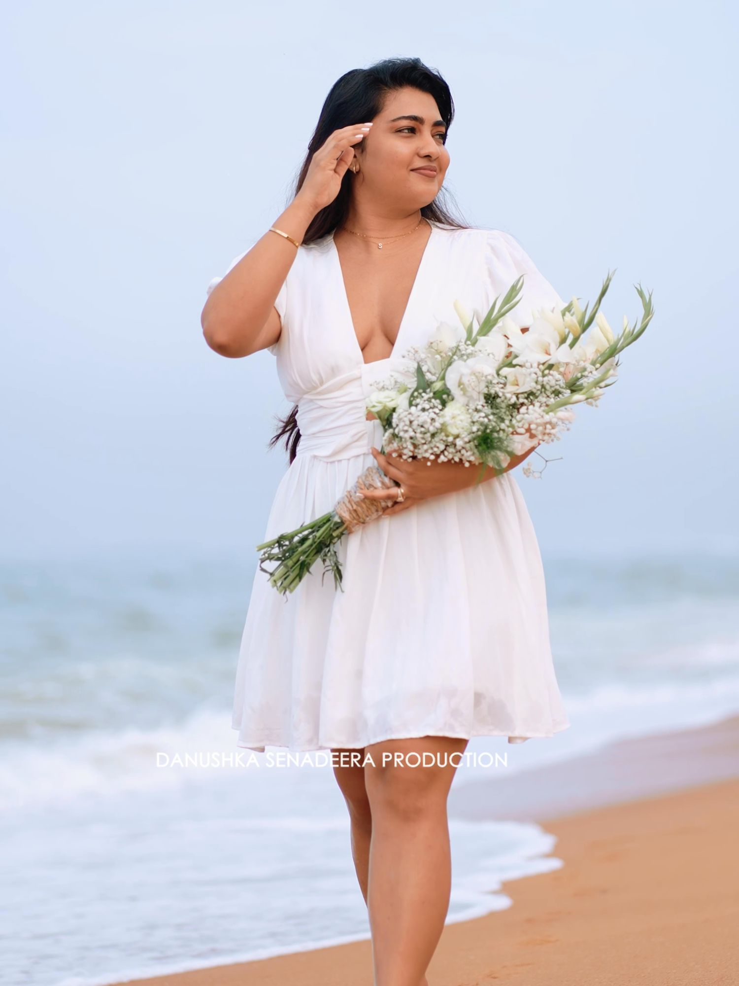 Walking through waves with flowers and a heart full of soft magic. For Inquries : 076 930 0008 #danushkasenadeera #manbehindthelens #SriLankanPhotographers #luxuryweddings #weddingphotographers @iam__sheff