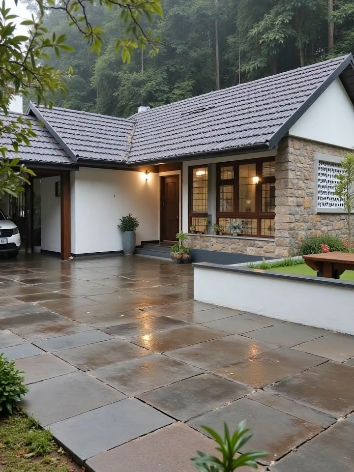 Mưa nặng hạt, sân đá loang nước phản chiếu ánh đèn hiên, làm nổi bật vẻ mộc mạc của mái ngói và tường đá giữa khu vườn xanh.” 🌧️✨ #nepnha #nhavuondep #nhadep #nhahiendai #nhavuon #nhacap4dep #nhacap4 #sanvuon #sanvuondep #nhacap4hiendai #tieucanh