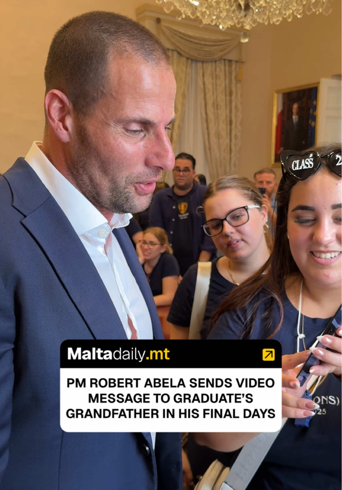 A deeply emotional moment unfolded inside Castille earlier today during the celebrations of Malta’s freshly graduated law students, just one day after their official graduation ceremony. Prime Minister Robert Abela welcomed a large group of new lawyers inside Castille during their graduation celebrations. The atmosphere was lively and full of excitement as the Prime Minister, himself a lawyer, congratulated the graduates and joined in their celebrations. Amid the joyful chaos, one young graduate approached the Prime Minister to share a personal story about her grandfather Toni, who suffers from leukemia and is currently receiving end-of-life care at St. Vincent De Paul Residence, she explained. The graduate, speaking with emotion, said that her grandfather’s health had deteriorated significantly and that he was at the final stage of his life. Moved by her words, Prime Minister Abela immediately agreed to record a personal video message for Toni. Stepping aside for a moment, the Prime Minister recorded a heartfelt message, telling Toni that he and his family were in his thoughts and prayers. He wished him courage and reassurance, sending strength during this difficult time. Abela then offered the young graduate words of encouragement, praising her love and dedication toward her grandfather. Before their exchange ended, the Prime Minister made a sincere promise that in the coming days he would personally visit Toni at St. Vincent De Paul Residence. #MaltaDaily 