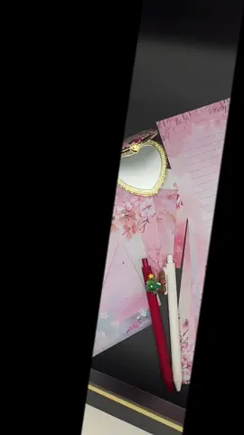 A little piece of calm and beauty in one box. Five cherry-blossom envelopes, five matching letter sheets, two cute pens, and a vintage-style heart mirror — all packed in an elegant black gift box with a golden bow. Perfect for gifting, journaling, pen-pals, or anyone who loves soft, aesthetic things. It’s simple, pretty, and feels like a small moment of peace. 🌸✨.  #AestheticStationery #CuteGiftSet #CherryBlossomVibes #KawaiiFinds #GiftIdeasForHer