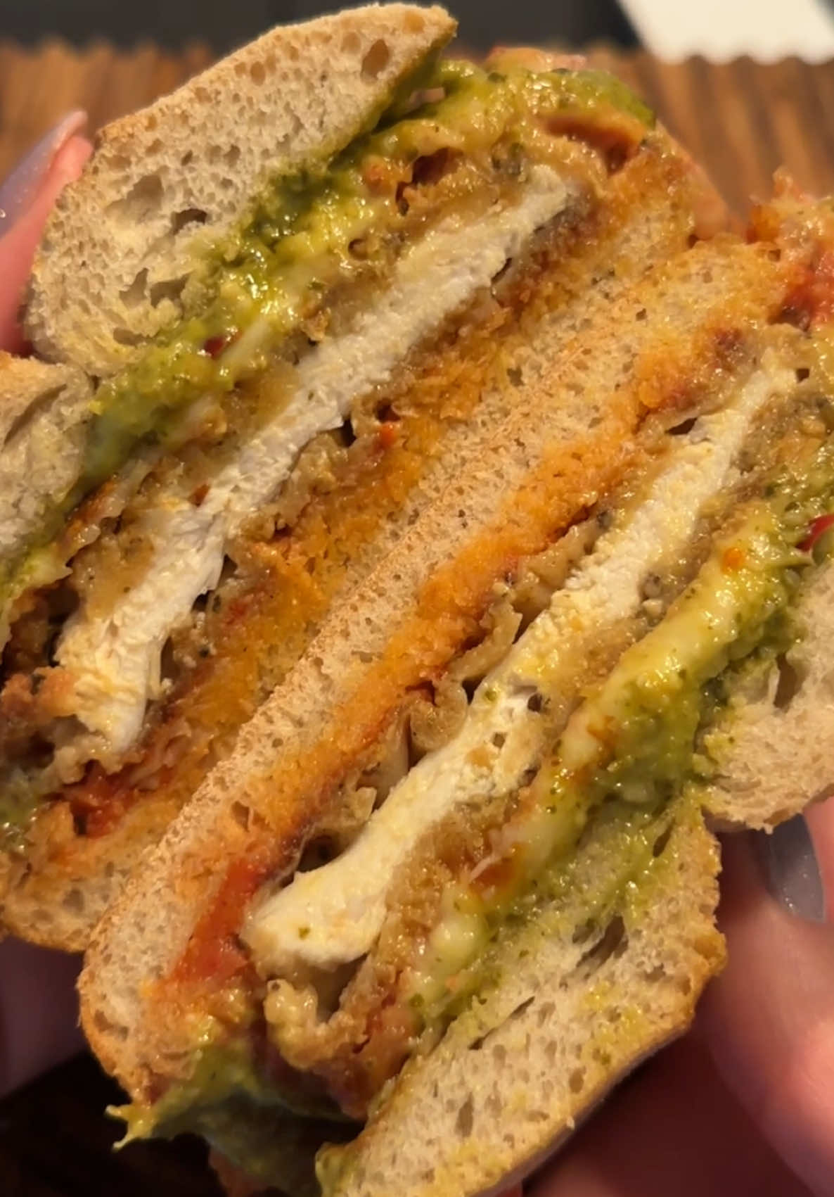 Chicken Parmesan&Pesto Sandwich🥪 Crispy chicken, rich tomato sauce, fresh pesto, and melted cheese on warm ciabatta bread🍅 All you need is:  •ciabatta 🍞 •chicken breast(seasoned with salt, black pepper, smoked paprika)🍗 + dredged in flour + coated in beaten eggs + covered in breadcrumbs(seasoned with salt, black pepper, oregano, Parmesan cheese) •tomato sauce🥫 •garlic🧄 •basil(*optional)🌿 •mozarella cheese🥛 •pesto🥣 HOW TO MAKE:  CHICKEN CUTLETS 1.	Slice the chicken breasts horizontally to make 2 thin cutlets. 2.	Season both sides with salt, pepper, smoked paprika. 3 . Bread the chicken 	Coat each chicken cutlet: 	• Dredge in flour → shake off excess 	• Dip into egg 	• Press into breadcrumb mixture until fully coated 4. Heat  oil in a skillet over medium heat. 5. Add the breaded chicken and cook 3–4 minutes per side, until golden brown and cooked through.  THE SAUCE 1. Heat olive oil in a pan and sauté garlic for 30 seconds. 2. Add tomato sauce (crushed tomatoes) , salt, black pepper and oregano. 3. Simmer for 10–15 minutes until slightly thickened. 4. Stir in basil if using. CHICKEN PARM 1. Preheat your oven.  2. Spoon marinara over each piece of chicken. 3. Add mozzarella slices and sprinkle Parmesan on top. 4. Bake until the cheese is fully melted and golden.  ASSEMBLE THE SANDWICH  1.Place the chicken parm on a toasted ciabatta roll. Sprinkle with Parmesan and add fresh basil if desired. 2. Spread pesto on the other slice of ciabatta. 3. Close the sandwich and serve. Enjoy💛 #chickenparm #chickenparmsandwich #chickensandwhich #chickenpestosandwich #EasyRecipes 