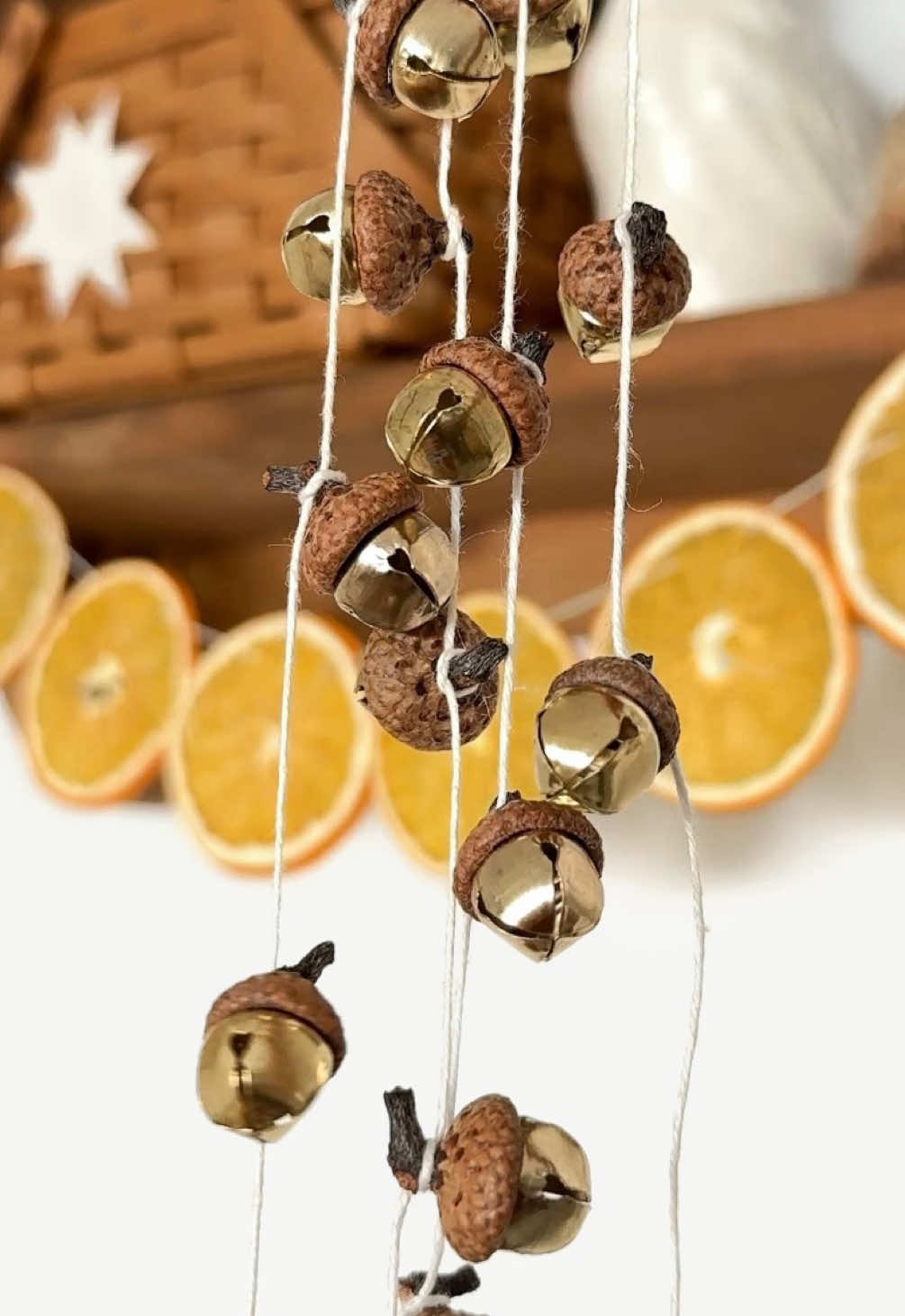 mini acorn bell garland ✨ I found these tiny acorn caps in my collection the other day and thought they’d be perfect as little whimsical bells! They are so easy to make using acorn caps in any size. I recommend having an assortment of bells so that you can match each one to the right sized bell.  To make, use glue to attach a bell to each cap. Let them dry completely then tie a twine around each acorn stem to turn into a garland. You can also turn these into ornaments or make a grouping of them to add to gifts! #naturecrafts #lowwastechristmas #diychristmasdecor #cottagecorechristmas #handmadeholiday 