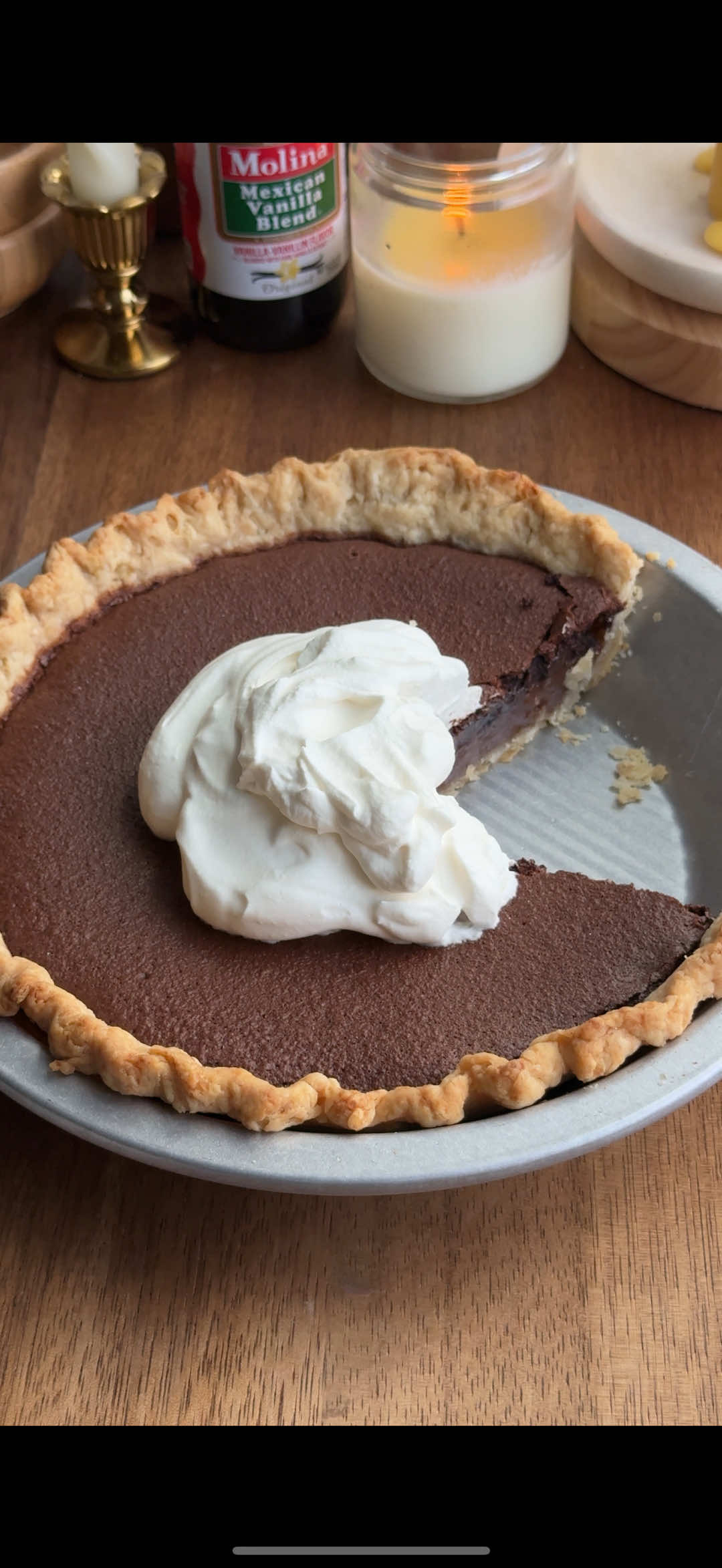 FILM TO TABLES SERIES EP 21: Minny’s chocolate pie from The Help 🍫🥧with my version of her “special ingredient” aka a piped chocolate ganache lol  This is food stylist Lee Ann Flemming’s recipe from the movie:  INGREDIENTS • 1 store-bought or homemade pie dough   • 1 ½ cups sugar • 3 tbsp unsweetened cocoa powder • 4 tbsp unsalted butter, melted • 2 large eggs, beaten • ¾ cup evaporated milk • 1 tsp vanilla extract • ¼ tsp salt • Whipped cream, to serve INSTRUCTIONS 	1.	Blind bake crust at 375°F: 15 min with parchment + pie weights, then 5 min without. 	2.	Lower oven temp to 350°F. 	3.	In a bowl, whisk sugar, cocoa, and salt. 	4.	Add melted butter, eggs, evaporated milk, and vanilla; whisk until smooth. 	5.	Pour filling into the warm crust. 	6.	Bake 40–45 min, until the top is set with a slight jiggle. 	7.	If the crust edges brown too quickly, cover them loosely with foil. 	8.	Cool completely (2–3 hours) before slicing. 	9.	Serve with fresh whipped cream *note if you want the chocolate ganache “special ingredient” you can mix 1/4 cup of chocolate chips with 1 to 1.5 tablespoons of evaporated milk and melt together. Let the mixture chill until firmed enough to pipe through a piping bag to form your shape - if you’re mixing it with the batter you should melt it slightly in the microwave about 10 seconds so it’s soft enough to blend into the batter -also I would add 1-2tsp of flour to the dry ingredients if you’re adding the ganache  #thehelp #minnyschocolatepie #recioe #foodfromfilms #fyp    