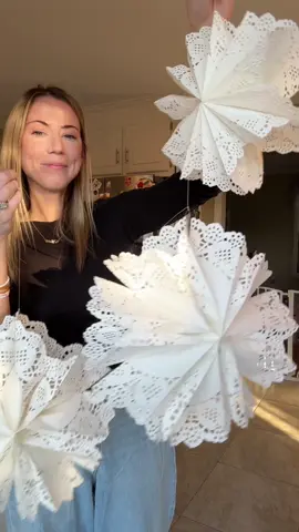 paper doilie snowflakes!!! made these last year and ofcourse had to make some more 😇❄️✨ so easy and dollar tree sells the dollies!! #diychristmas #diychristmasdecor #christmascrafts #papersnowflakes #papercrafts 