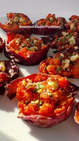 These smashed sweet potatoes are an easy side dish. I slice the potatoes into rounds and quickly boil them until they're just tender enough to smash. I drizzle the potatoes with oil and seasonings and roast them. They turn out soft and fluffy in the middle with crisp edges. Then I top them with walnuts and chives. ➡️ Full recipe linked in bio. #thanksgivingrecipes #sidedish #sweetpotato #potatoes #EasyRecipe 