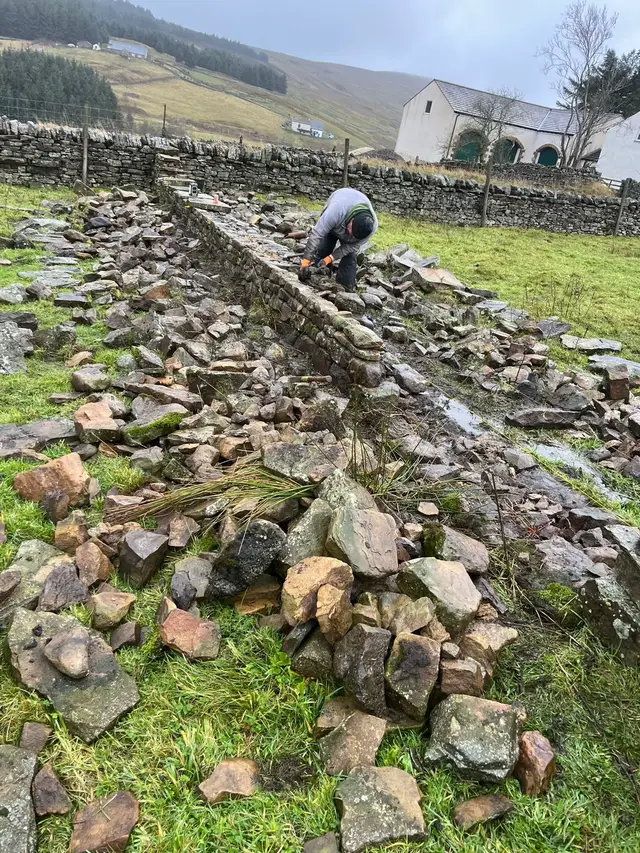 The first stretch of wall built up on a big rebuild job! Was going well until we rocked up on wednesday and snow stopped play! #winter #stonework #rebuild #viral #fyp 