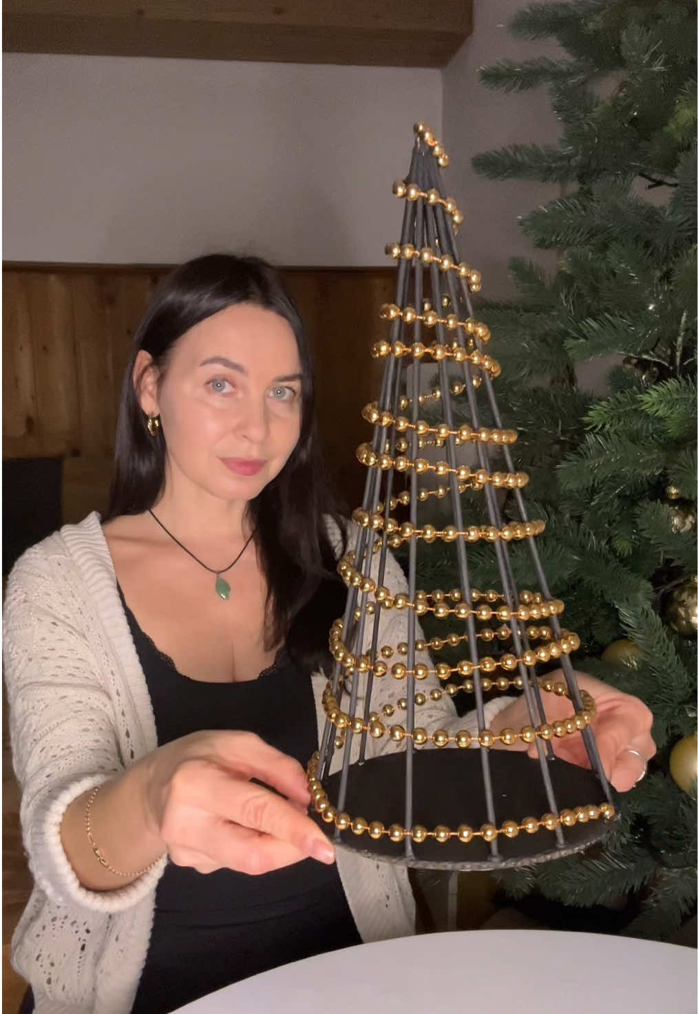 DIY Christmas tree 🌲 is made from bamboo barbecue sticks. I used 12  sticks , a small piece of cardboard, and some Christmas tree beads.  ✨I glued the sticks on with a hot glue gun and painted them with black acrylic paint.  ✨You can add battery-powered garland if you like, although it looks great without them. #DIY#christmasdecor#christmastree#christmascraft#homedecor 