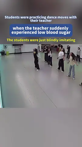 Students were practicing dance moves with their teacher when she suddenly experienced low blood sugar.  The students were just blindly imitating.