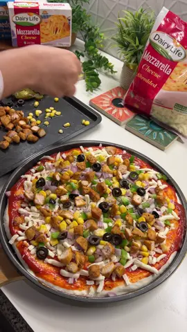 Tag your cousin & share this recipe with them 🍕  Written recipe 📄  Ingredients For the Dough   • 3½ cups (437g) all-purpose or bread flour  • 1⅓ cups + 1 tbsp (338 ml) lukewarm water  • 3 tbsp + 1 tsp olive oil  • 1½ tsp salt  • 1¼ tsp instant yeast  • 1 tsp sugar For the Chicken Topping  • 1/3 kg boneless chicken, cut into small cubes  • Salt, to taste  • Black pepper, to taste  • Chilli powder, to taste  • Paprika powder, to taste  • Oregano, to taste  • 1–2 tablespoons oil, for cooking For Assembling the Pizza  • Dairy Life mozzarella cheese (generous amount for the base)  • Cooked seasoned chicken cubes  • Mixed vegetables (capsicum, onions, etc.)  • Sweet corn  • Jalapeños  • Additional mozzarella cheese for topping Instructions 1. Prepare the Dough   1. In a bowl, mix lukewarm water, olive oil, sugar, and instant yeast.  2. Add flour and salt. Stir until a sticky dough forms.  3. Cover and let it rest for 20 minutes.  4. Perform a stretch & fold 3 times, every 20 minutes (wet your hands, grab one edge of the dough, pull up, fold over, rotate the bowl, repeat).  5. After the folds, cover and let the dough rest until slightly puffy (about 1 hour). 2. Cook the Chicken  1. Season chicken cubes with salt, black pepper, chilli powder, paprika, and oregano.  2. Heat oil in a pan.  3. Cook on medium heat until fully cooked and slightly golden.  4. Set aside. 3. Assemble the Pizza  1. Preheat oven to 220°C (430°F).  2. Shape or stretch your dough into a pizza base.  3. Place it onto a greased or lined baking tray.  4. Add a generous layer of mozzarella cheese on the base.  5. Add the cooked chicken.  6. Add mixed vegetables, sweet corn, and jalapeños.  7. Top with another layer of mozzarella cheese. 4. Bake  1. Bake for 20-25 minutes, or until crust is golden and cheese is melted and bubbly. #MadewithDairylife #Cheese #Dairylife @youngsfoodpk  #EasyRecipe #homemade      