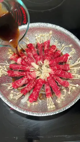 25-minute Beef Enoki Rolls Would you try this?? Because omg… this came out so juicy and cozy. Recipe: 	•	1 lb sliced beef (Angus prime chuck rolls) 	•	1 pack enoki mushrooms 	•	1/2 chopped onion 	•	1 egg 	•	1 tbsp oil Broth: 	•	1/4 cup soy sauce 	•	1/2 cup water 	•	1/2 tbsp bonito powder 	•	1 tbsp sugar Garnish: green onion, sesame Steps: 	1.	Split enoki into small bundles. 	2.	Cut beef to fit and wrap around each bundle. Roll tightly. 	3.	Mix broth. 	4.	Heat oil → stir onions 10 sec → add rolls. 	5.	Pour broth, cover 5–7 mins. 	6.	Add beaten egg, cover 3 mins. 	7.	Garnish & done! #beefenokiroll #beef #enoki #cooking #Recipe 