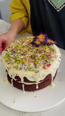 The fluffiest, most moist carrot cake… thanks to one simple thing: pineapple. It keeps the cake unbelievably soft, and the pour-over cream cheese icing makes it even better. Two layers, simple ingredients, and that pretty drip on top. Full method below — save this one for your next gathering. Find the full recipe on my website. Ingredients Main Ingredients 2 cups plain flour (310 grams) 2 teaspoons baking soda 2 teaspoons baking powder 1 teaspoon salt 2 teaspoons ground cinnamon 1⁄2 teaspoon ground nutmeg 1⁄2 teaspoon ground ginger 1 1⁄2 cups white sugar (300 grams) 1⁄2 cup brown sugar (85 grams) 1 cup vegetable or canola oil 4 eggs, room temperature 2 teaspoons vanilla essence 2 cups grated carrots 1 cup crushed pineapple, juice reserved 1 cup shredded coconut 1 cup chopped walnuts Cream Cheese Icing 250 grams cream cheese, softened 2 cups icing sugar  reserved pineapple juice 1 teaspoon vanilla essence Preheat the oven to 170°C (fan-forced) (340°F). Grease and line two 20 cm round cake tins. In a large bowl, mix the flour, baking soda, baking powder, salt, cinnamon, nutmeg and ginger. In another bowl, beat the white sugar, brown sugar, eggs, oil and vanilla essence until smooth. Add the grated carrots and the drained crushed pineapple, then fold in the shredded coconut. Add the dry mixture to the wet bowl and gently fold until just combined. Stir through the chopped walnuts. Divide the batter between the two tins and bake for 40 minutes, or until a toothpick inserted in the centre comes out clean. Cool the cakes completely. For the icing, beat the cream cheese until smooth, then add the icing sugar and beat again. Mix in the vanilla essence and add about 2 tablespoons of the reserved pineapple juice to make it creamy and pourable. Place one cake on a serving plate and pour over half the icing. Add the second cake on top. Keep a little icing in the bowl, add another 3–4 tablespoons pineapple juice to loosen it, then pour it over the top so it gently drips down the sides. #fyppppppppppppppppppppppp #fyp #cake #carrotcake #dessert 