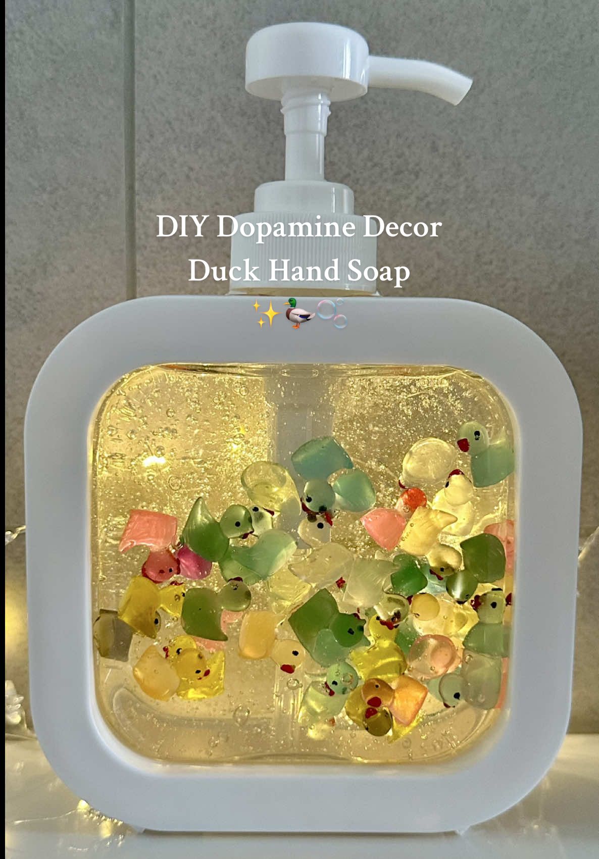 DIY Duck Hand Soap ✨🦆🫧 Need a daily serotonin boost? Turn your hand washing routine into a little moment of joy! 🛁💛 Here is what you need to make your own floating rubber duck pond: • A clear soap dispenser 🧴 • Clear liquid hand soap 🫧 • Mini rubber ducks 🐤 Save this for some easy DIY dopamine decor inspo! ✨ #diysoap #handemadesoap #dopaminedecor #handsoaps #rubberducks DIY duck hand soap, rubber duckie soap, hand soap refill, unique gift idea, hand soap ideas, fun home decor