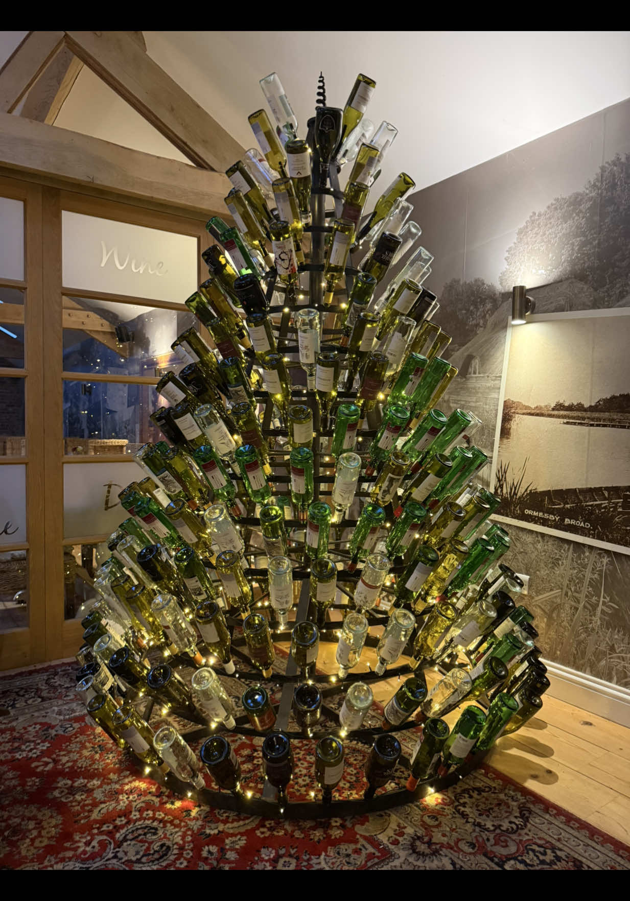 Our wine bottle Christmas tree is back!!  #theboathouseormesby #christmas #christmastree #christmasdecor 