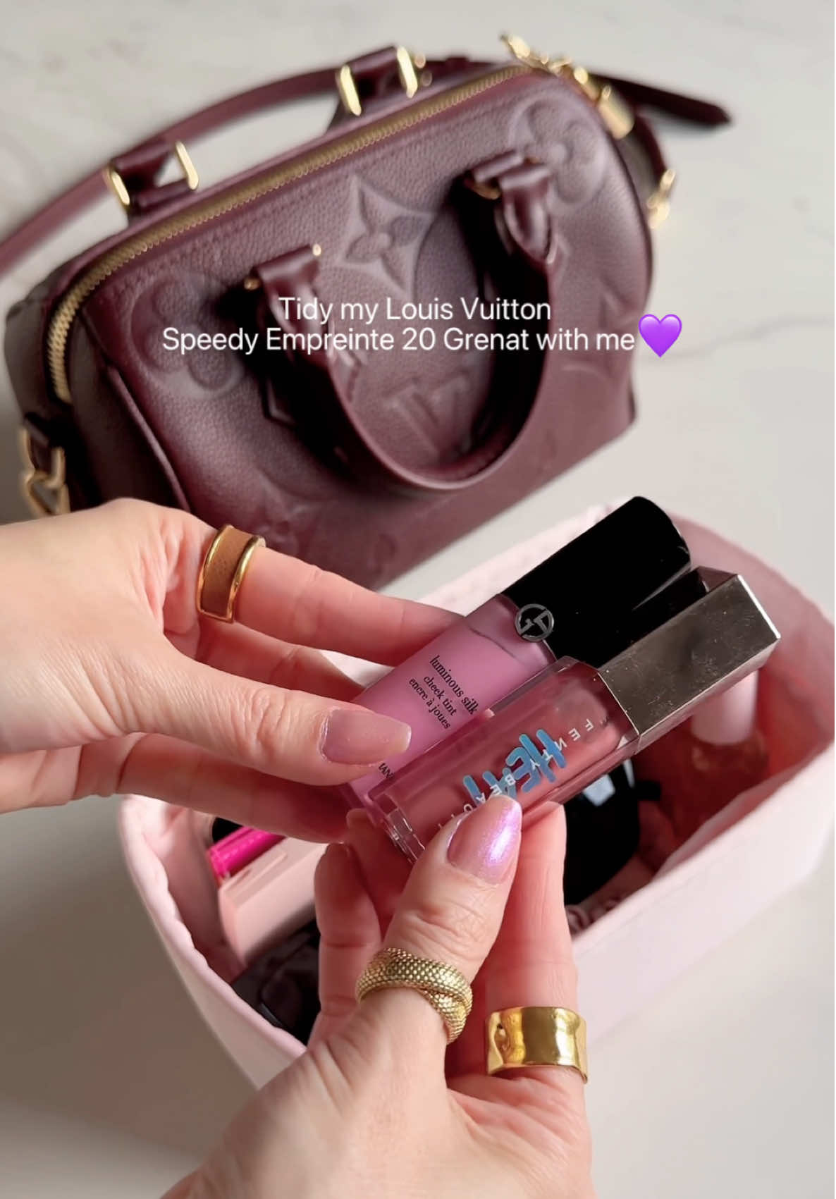 Tidy my @Louis Vuitton Speedy Bandoulière Empreinte 20 Grenat with me 💜 Adding an organiser is a game changer! This helps protect the lining of my bag as well as stop me from rummaging in the bag to find things I need.  Love the quality of @dgazglobal organisers and the colours they offer. Essentials @YSL Beauty @Fenty Beauty @Armani beauty @Diorbeauty @Gisou  How many lip products do you have in your bag right now? #louisvuittonbags #girlaesthetics #baglovers #burgundybag #luxelifestyle Beauty haul . Beauty community. Makeup favourites. viral makeup, makeup looks, minimal makeup, beauty product recommendations. aesthetic beauty, Vanity makeup. Makeup tutorial. Makeup collection. Glam makeup. Bag organisers. Dior beauty . Lip gloss . Perfume . Bag lovers . Fenty beauty gloss bomb . YSL beauty. 