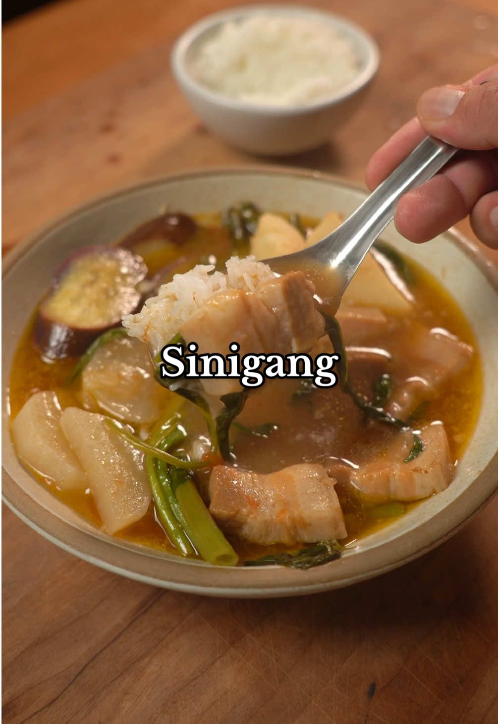 Sinigang Get the full recipe on https://provecho.co/platform/recipe/btqliNpP4hL6Hb5h8ACr Ingredients * 2 lbs pork belly or pork ribs(cut into bite-sized pieces) * 3 tbsp neutral oil * 2 medium onions(cut into quarters) * 3 tomatoes(cut into quarters) * 10 cups water * 1 pork stock cube * 3 tbsp fish sauce * 1-1.5 cups tamarind pulp or 1-2 packets tamarind soup mix(I like using both) * 4 taro(peeled and cut into chunks) * 1 daikon(cut into 1/4 inch slices) * 1 eggplant(cut into 1/4 inch slices) * 1 bunch long beans(cut into 3inch segments) * 1 bunch water spinach(Kangkong) * Salt to taste #comfortfood #sinigang #porkbelly #Recipe #soup 