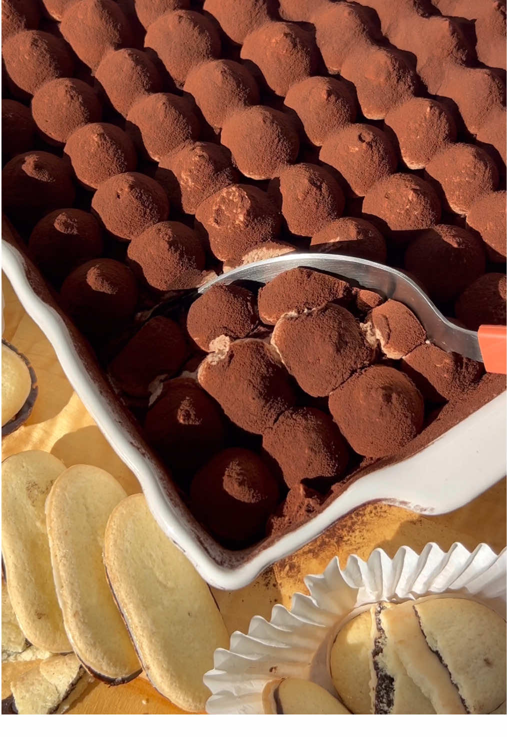 Is it too early to start the Christmas baking? 🤭 PEPPERMINT MOCHA TIRAMISU RECIPE: Chocolate ganache: * ¼ cup Heavy cream (57ml) * 1 cup Semi-sweet chocolate chips (200g) Cookie Layers: * Milano peppermint cookies (~36 cookies which is a little less than three 7oz packs) * Strong coffee (I made 500ml for dunking but you will have leftovers!) Mascarpone layer: * 2 ½ cups cold heavy whipping cream (600g) * ½ cup granulated sugar (108g) * ½ tsp vanilla * ½ tsp peppermint extract * 8 ounces cold mascarpone cheese  Topping: * Cocoa powder to taste (only add the topping when you’re about to serve it! So don’t add it before wrapping tightly and refrigerating overnight!) Instructions: * Start with the chocolate ganache! In a microwave-safe bowl, melt the chocolate chips with the heavy cream for 30 seconds. Stir VERY well until the chocolate is fully melted. Set that aside to cool down  * In a stand mixer with a whisk attachment, whip the heavy cream, vanilla, peppermint extract, and sugar until loose peaks form * Take that out and set it aside * Whip the cold mascarpone cheese and chocolate ganache very well until it’s silky in texture * Next, gradually add the whipped cream into the mascarpone while mixing on low speed with a paddle attachment  * Do that until the whipped cream is fully incorporated  * Grab your dish (I used a 9x9 square dish), and start with the cookie layer * For the first cookie layer, dunk each cookie in strong coffee (make sure the coffee isn’t hot), and then lay them flat all over the bottom of the dish * Add your first layer of mascarpone filling, add another layer of coffee-soaked cookies, and then a thin layer of mascarpone for the top * Before wrapping and refrigerating overnight, I like to make a fun pattern with the remaining mascarpone on top. If you don’t want to do that, just add the rest of the mascarpone and smooth it out * Wrap tightly with plastic wrap and refrigerate overnight * The next day, add a dusting of cocoa powder & serve! #tiramisu #peppermint #nobakedessert #christmasbaking 