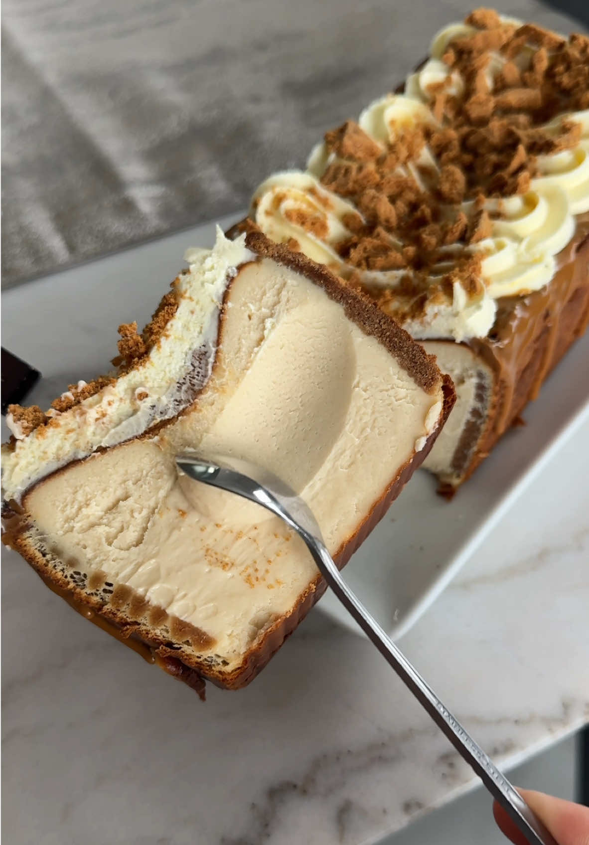 Biscoff Burnt Basque Cheesecake 🧀🍰 Anything with biscoff is a 10/10 in my books.  RECIPE: biscoff burnt basque cheesecake: 3 blocks (24 oz) softened cream cheese  1 cup sugar 3 eggs 1 tsp vanilla 1.5 tbsp flour 1 tsp cornstarch 1/2 jar biscoff 1.5 cups heavy cream whipped cream cheese: 4 tbsp cream cheese 1 cup heavy whipping cream 1/4 cup powdered sugar process: 1. ﻿﻿﻿Preheat the oven to 450F. 2. ﻿﻿﻿Combine the soft cream cheese, sugar, and eggs and mix until completely combined. 3. ﻿﻿﻿Add the cornstarch and flour. 4. ﻿﻿﻿Pour in the melted biscoff, vanilla & mix. 5. Add in the heavy cream until fully combined and smooth.  6. ﻿﻿﻿Pour the batter through a strainer into a loaf pan OR an 8 inch round pan that has been lined with parchment paper. **TIP: I lined my loaf pan with biscoff cookies, but they slightly burnt on top. I would suggest either cutting the cookies or covering them with the cheesecake to avoid this. 7. ﻿﻿﻿Bake for about 30-35 minutes. (You may need to add time depending on your oven). I used convection bake. **It should be jiggly in the center and dark on top when you remove it from the oven. 8. Allow the cake to cool completely before placing it in the refrigerator overnight. whipped cream: 1. ﻿﻿﻿Combine softened cream cheese, heavy cream, and powdered sugar until fully combined and whipped. Don't over mix! 2. ﻿﻿﻿The next day you can decorate with more biscoff spread & the whipped cream mixture & crushed cookies.  #basquecheesecake #burntbasquecheesecake #biscoff 