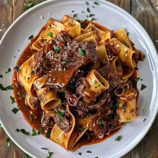 Don’t hesitate to make this.   It’s fantastic  Short Ribs Ragu With Pappardelle Ingredients: - 2 pounds beef short ribs - 2 tablespoons olive oil - 1 onion, chopped - 3 cloves garlic, minced - 1 cup beef broth - 1 can (28 oz) crushed tomatoes - 1 tablespoon tomato paste - 1 teaspoon dried thyme - Salt and pepper, to taste - 1 pound pappardelle noodles - Grated Parmesan cheese, for serving (optional) Instructions: 1. Preheat oven to 300°F (150°C). 2. Brown short ribs in olive oil, then set aside. 3. Cook onion and garlic until softened. 4. Add red wine, beef broth, crushed tomatoes, tomato paste, and thyme. Stir to combine. 5. Return short ribs to the pot, cover, and transfer to the oven. 6. Braise for 2 1/2 hours or until short ribs are tender. 7. Cook pappardelle noodles al dente, then toss with the ragu. 8. Serve with grated Parmesan cheese, if desired.