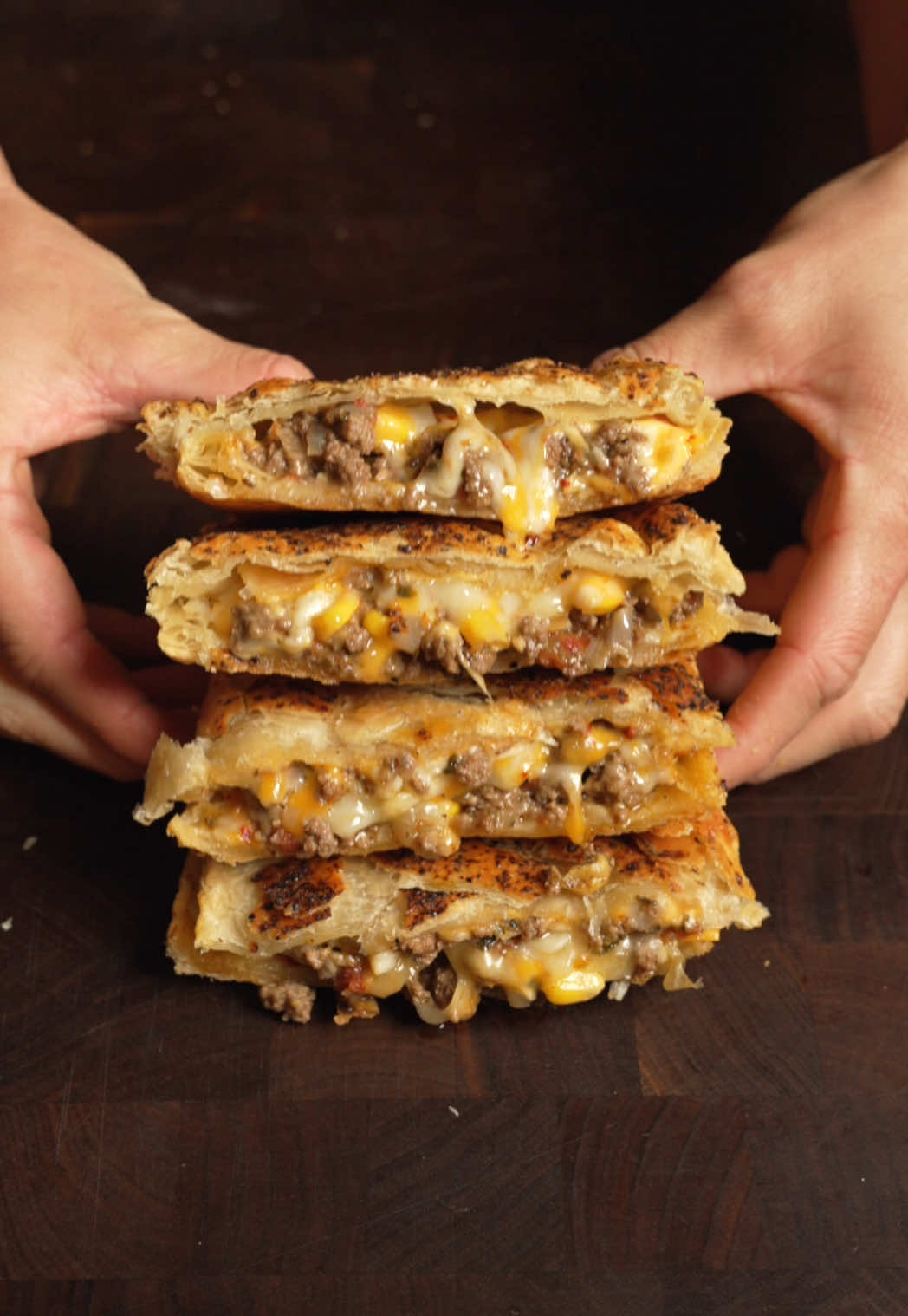 Taco Hot Pocket 🌮 Ingredients * 1 lb ground beef * 1 small onion, diced * 1 packet taco seasoning * ½ cup corn  * ½ cup fire-roasted tomatoes  * Salt & pepper to taste * Splash of beef or chicken broth * 2 tbsp sour cream * 2 tbsp chopped cilantro * 2 sheets puff pastry, thawed * Colby jack cheese  * 1 egg (for egg wash) Avo crema * 1 ripe avocado * 1 jalapeño  * 2-4 garlic cloves * Handful of cilantro (about ¼ cup packed) * 1/4 cup sour cream * Juice of 1–2 limes * 1 tsp chicken bouillon  * 1–3 tbsp water (to thin if needed) * Salt to taste #taco #hotpocket 