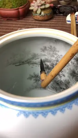 The ceramic artisans of Jingdezhen skillfully depict meticulous landscape paintings within the jars. The painting process flows like clouds and water, with the brushwork flowing effortlessly. Netizens comment: “There’s something profound within; it’s a hidden world. This is truly a national treasure-level craft.” #CeramicCulture #artistsoftiktoks  #porcelain  #ceramics  #potterhead