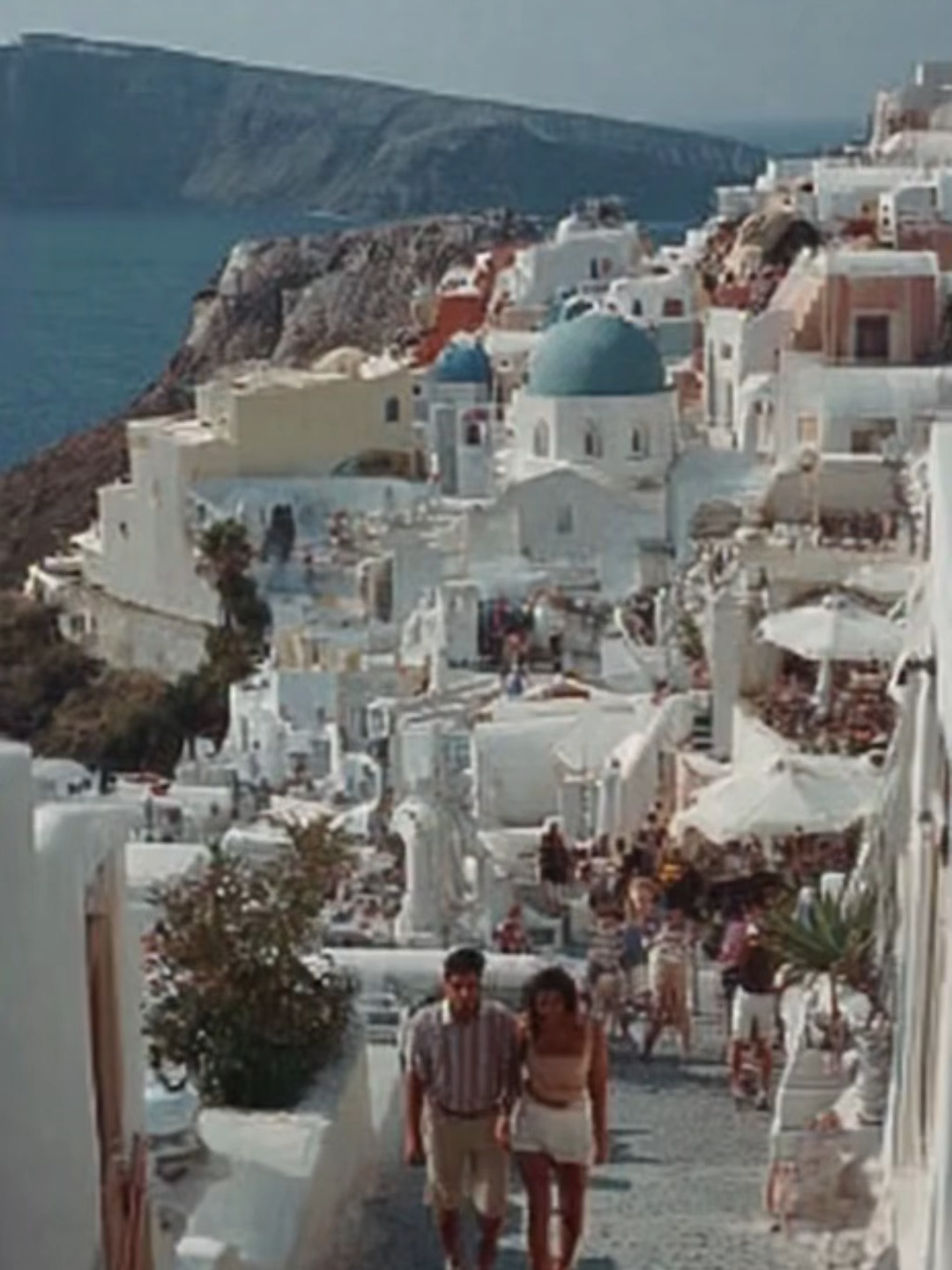 A serene POV walk through Santorini’s iconic cliffside paths at sunset, where golden light reflects off whitewashed walls and blue-domed rooftops begin to glow. Warm hues spill across the Aegean Sea as the evening breeze moves softly through narrow alleys, creating a dreamy Mediterranean escape. #SantoriniSunset #GreeceTravel #AegeanViews #IslandPathways #MediterraneanMood