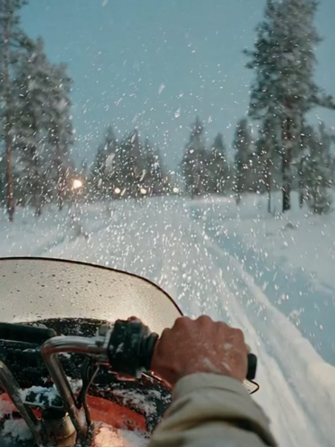 Snowmobile Through Frozen Nordic Forest – Nordic Winter Adventure A fast, immersive ride through a frozen Scandinavian forest at dusk, with snowflakes drifting in the headlamp beam, frosted pine branches shimmering, and the northern lights beginning to glow above. A deep-blue Arctic sky, crisp winter silence, and pure Nordic wilderness energy. #NordicAdventure #WinterEscape #SnowyForest #ArcticVibes #ScandinaviaTravel
